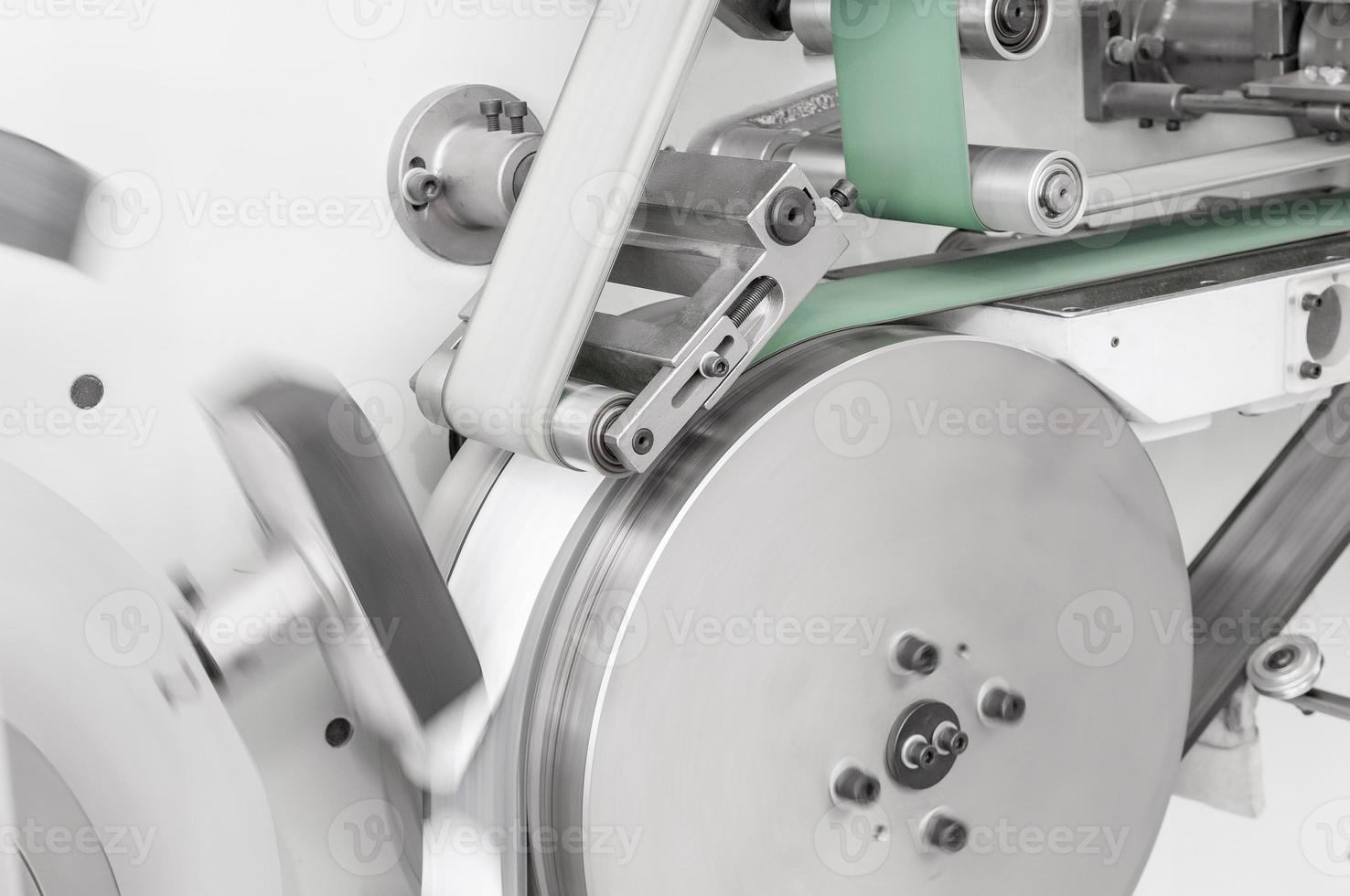 equipment and mechanism with a moving cloth tape on rollers closeup. in the production of moving fabric tape on network rollers photo