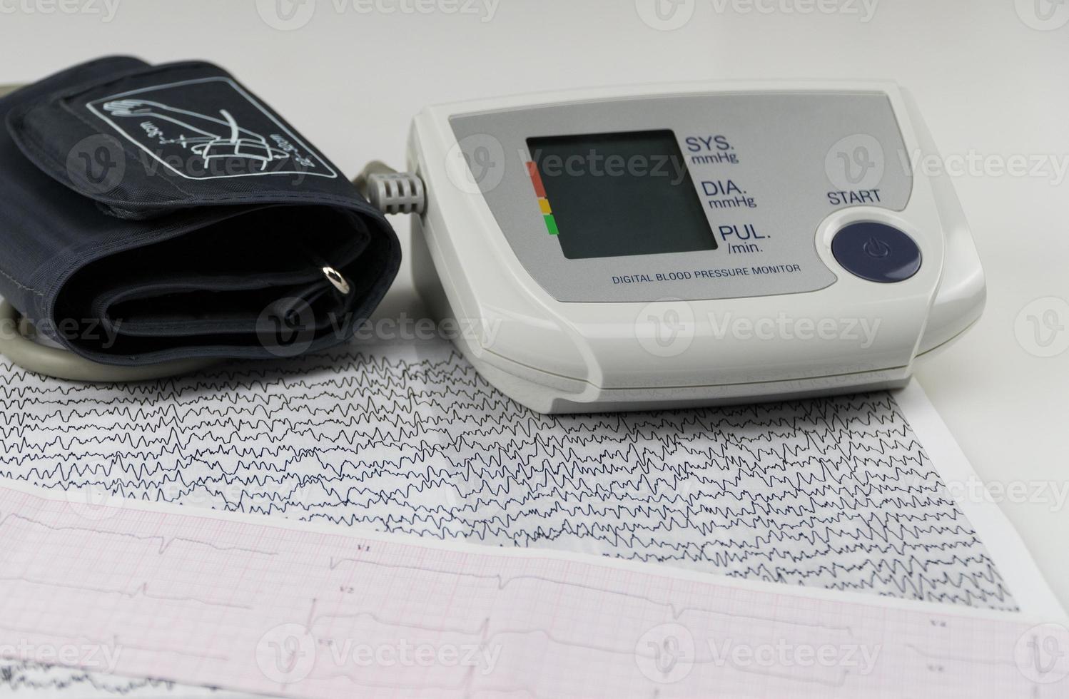 electric blood pressure monitor with ecg chart. modern household tonometer photo