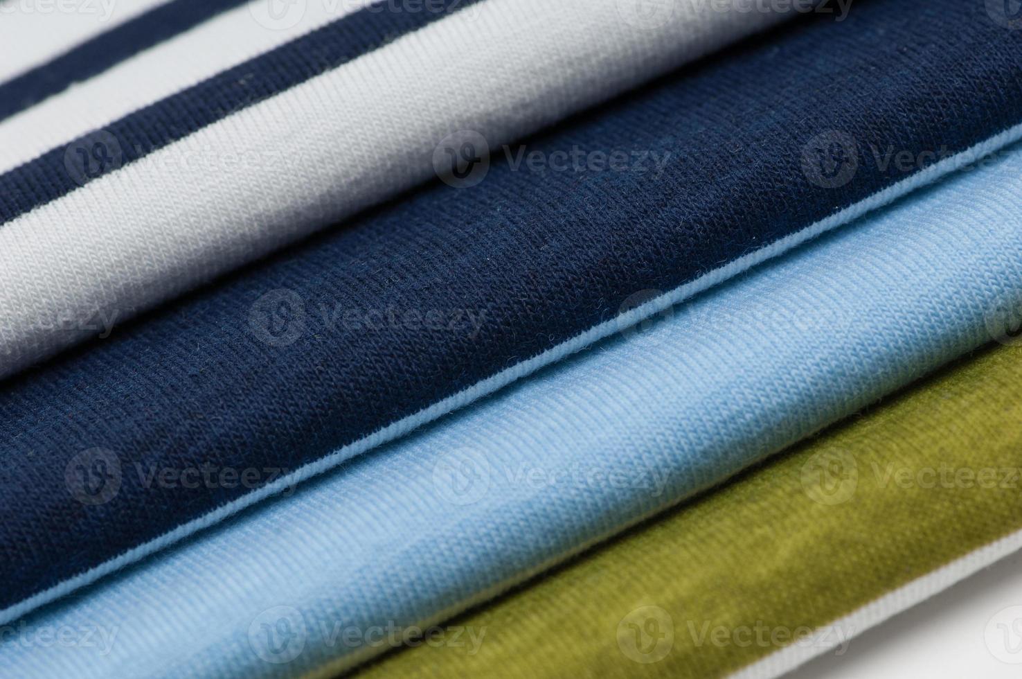 background of colorful fabrics and textiles stacked on one another photo