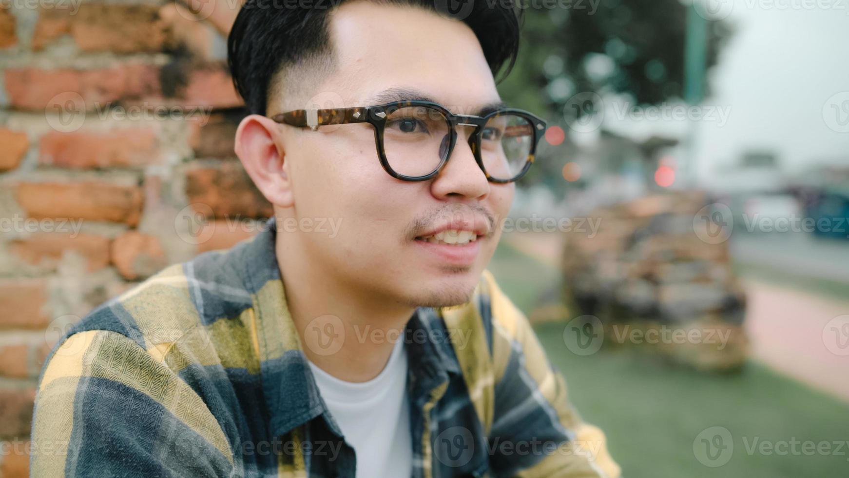 Traveler Asian man feeling happy smiling to camera holiday trip at Ayutthaya, Thailand, backpacker male enjoy his journey at amazing landmark in traditional city. Lifestyle men travel holidays concept photo