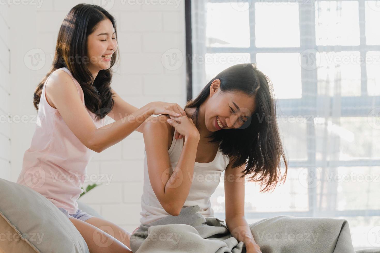 Japanese Mother And Daughter Massage Asian Lesbian lgbtq women couple massage each other at home. Young Asia lover female happy relax rest together after wake up, body wellness in bedroom at home in the morning concept. 5486392