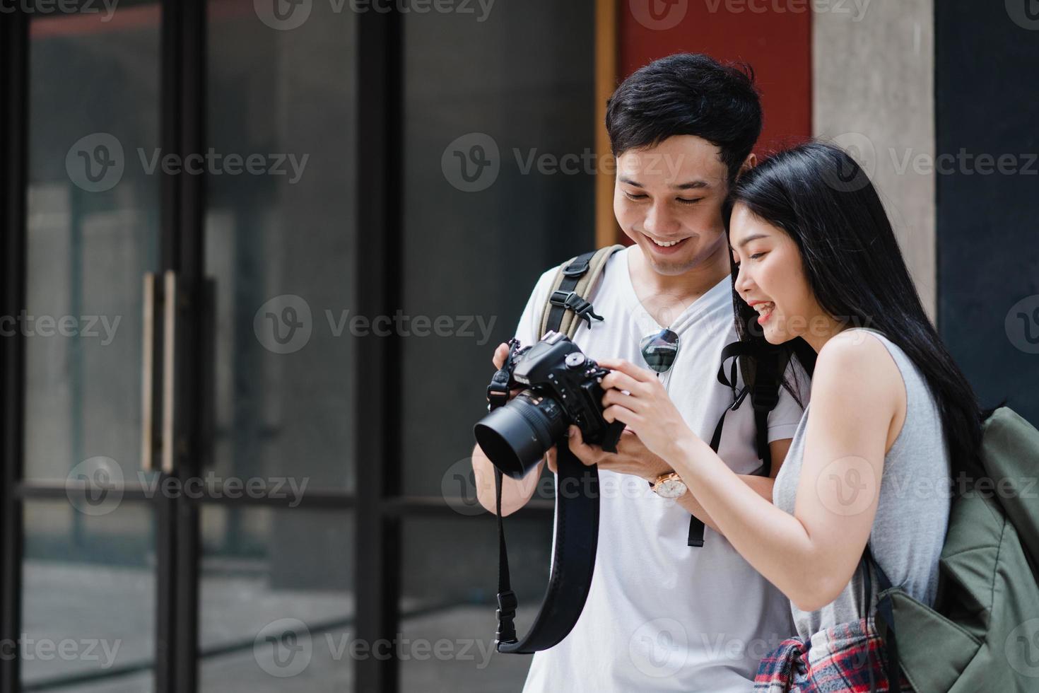 Traveler Asian couple using camera for take a picture while spending holiday trip at Beijing, China, couple enjoy journey at amazing landmark in city. Lifestyle couple travel in city concept. photo
