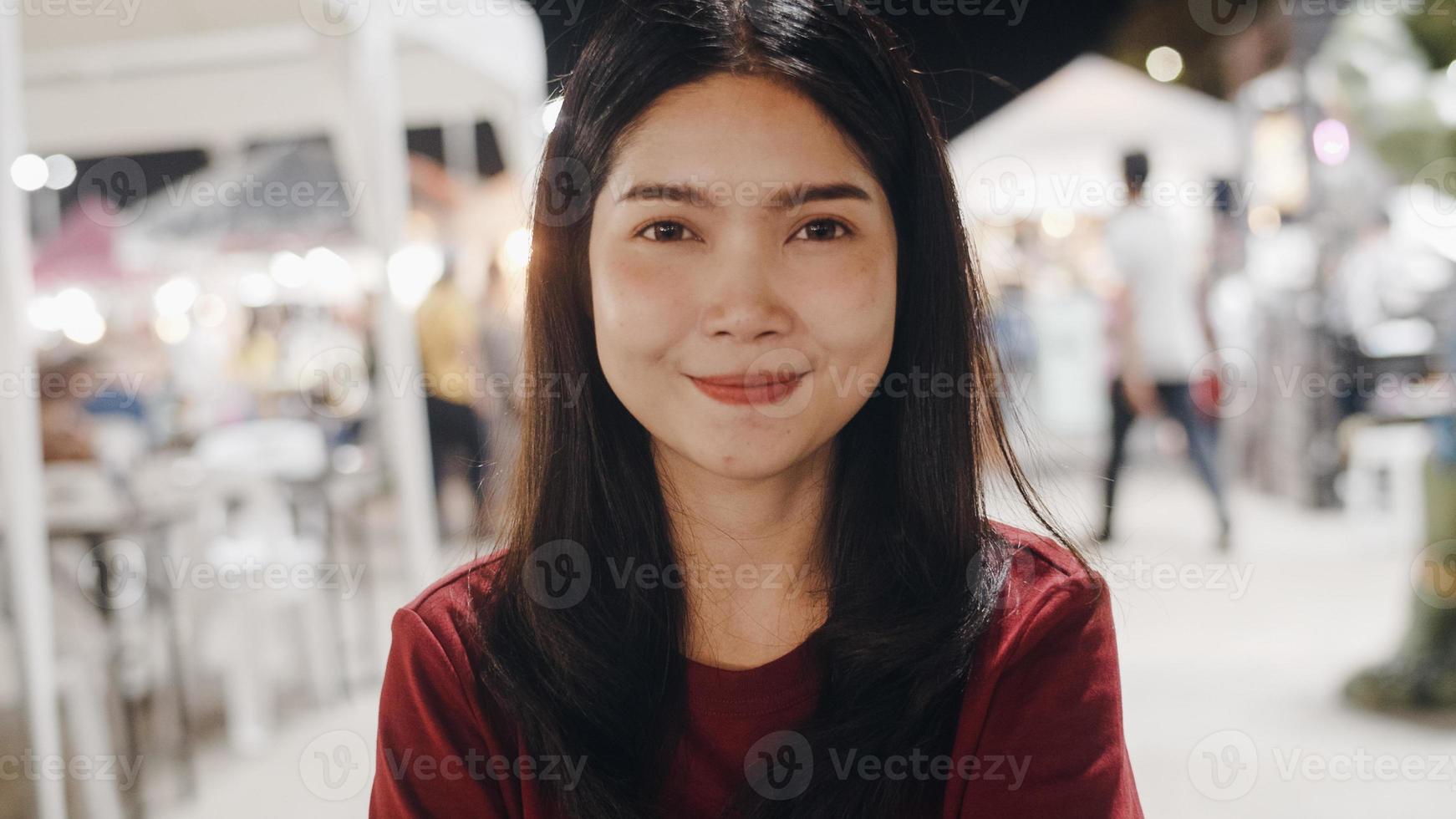 Portrait traveler Asian woman feeling happy smiling looking to camera holiday trip at Bangkok, Thailand, backpacker Asia female enjoy their journey in night at Khao San Road. photo