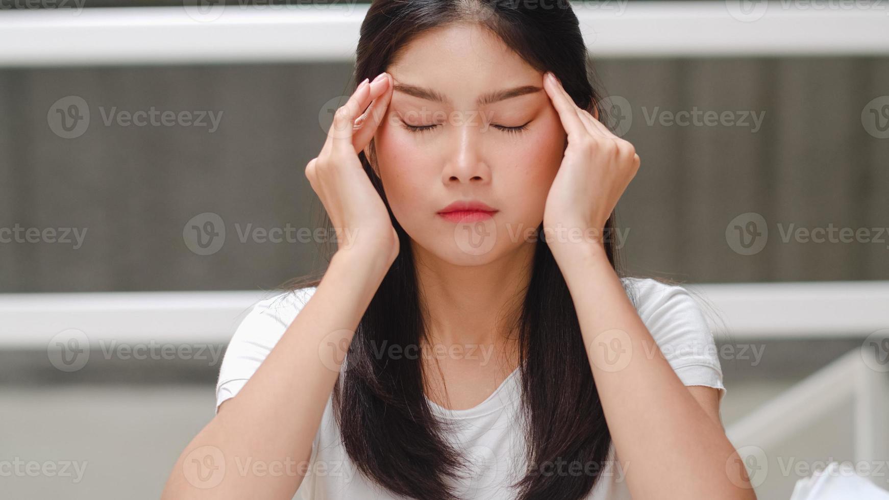 Asian student women read books in library at university. Young undergraduate girl stress tired have problem while study hard for knowledge on lecture desk at college campus concept. photo