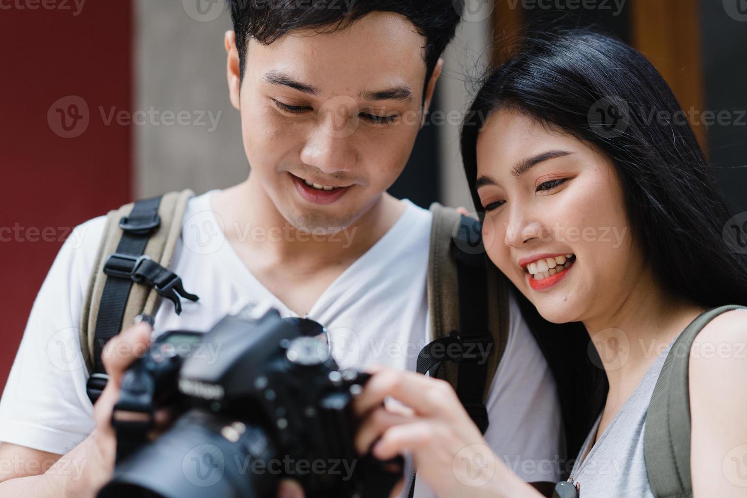 Traveler Asian couple using camera for take a picture while spending holiday trip at Beijing, China, couple enjoy journey at amazing landmark in city. Lifestyle couple travel in city concept. photo