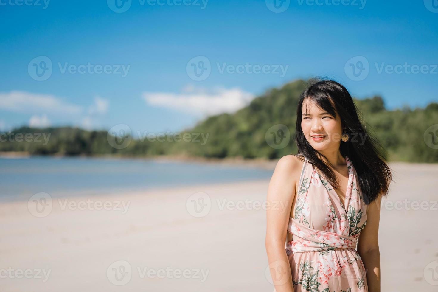 hermosa joven asiática feliz relajarse caminando en la playa cerca del mar. las mujeres de estilo de vida viajan en concepto de playa. foto