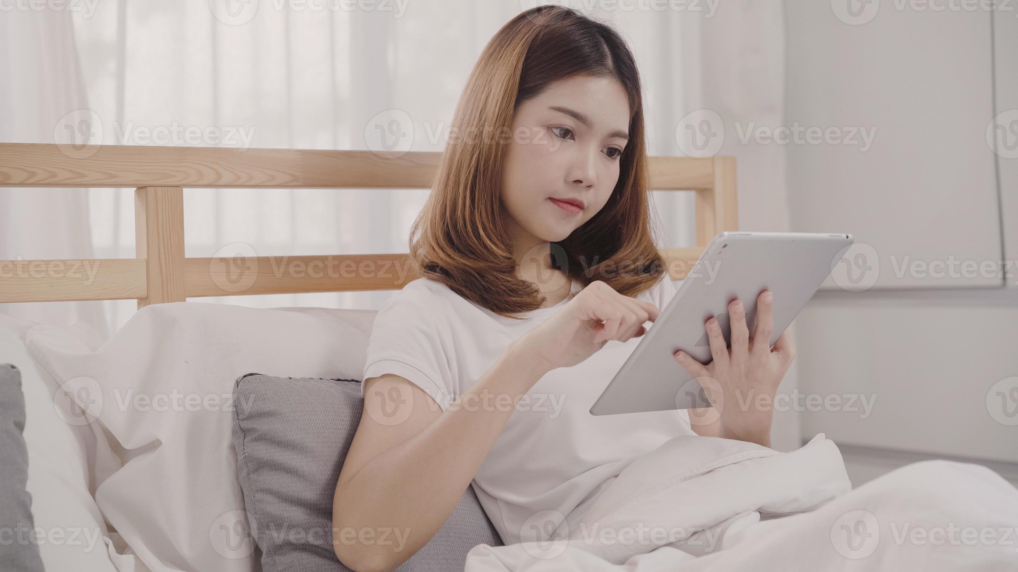 Young Asian woman using tablet while