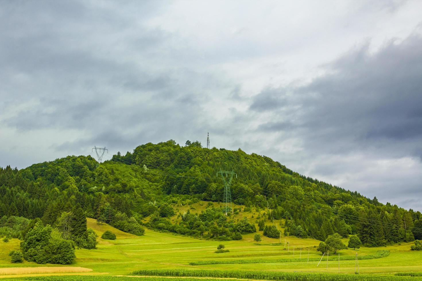 Wonderful mountain and forest landscape with farmland in Slovenia. photo