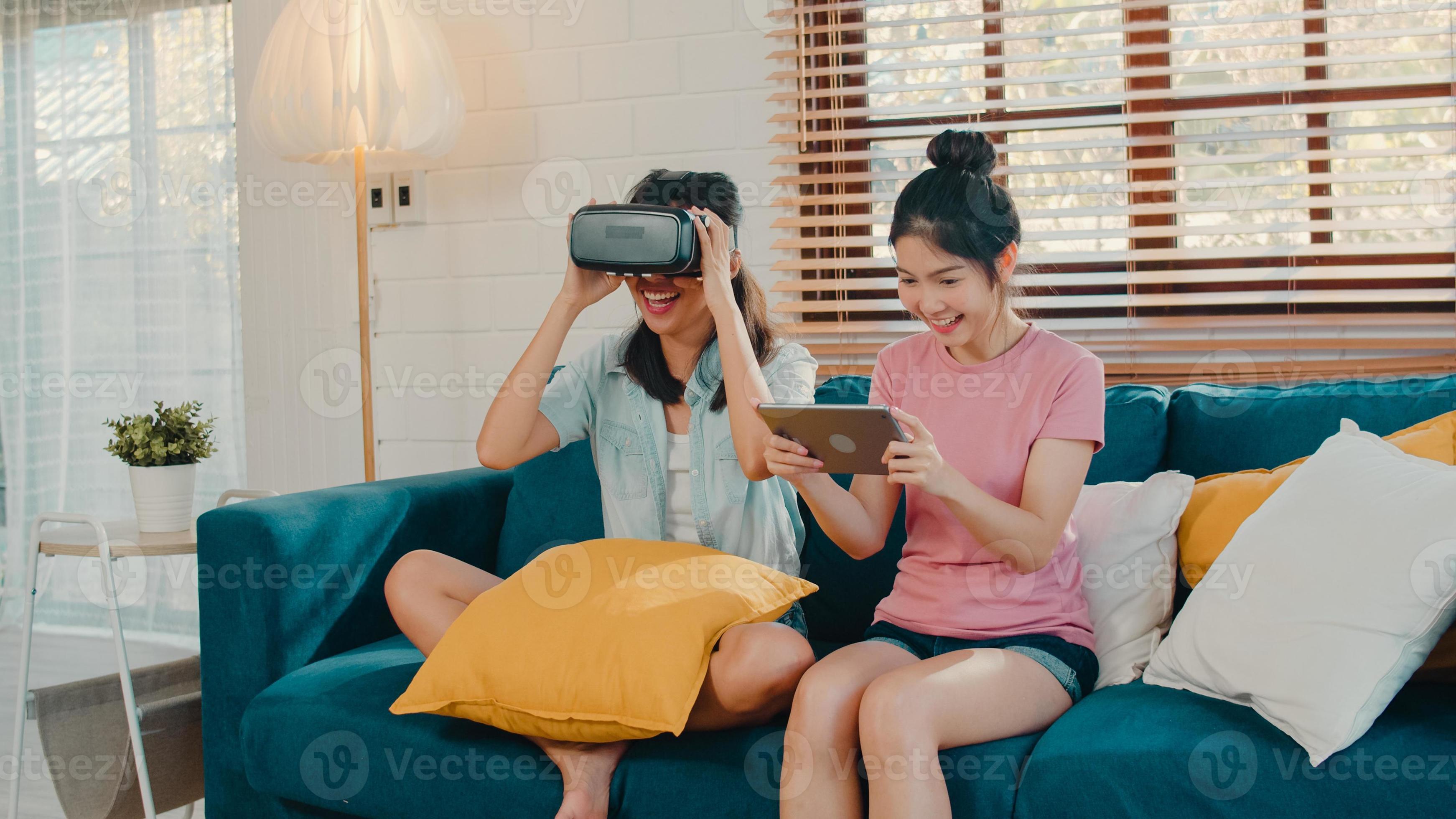 præsentation bruger regional Young Lesbian lgbtq Asian women couple using tablet at home, Asian lover  female feeling happy fun and virtual reality, VR playing games together  while lying sofa in living room at home concept.