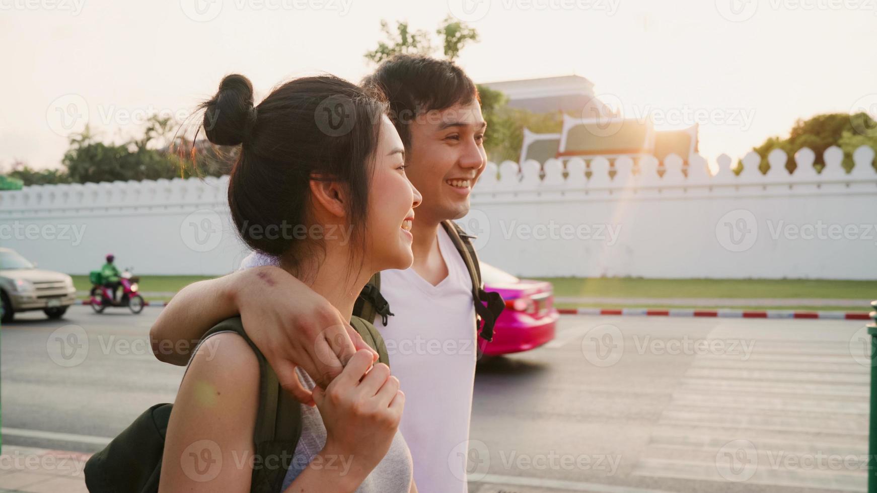 Traveler Asian couple traveling and walking in Bangkok, Thailand, sweet Asia couple feeling happy spending sweet time in holiday trip in sunset. Lifestyle couple travel in city concept. photo