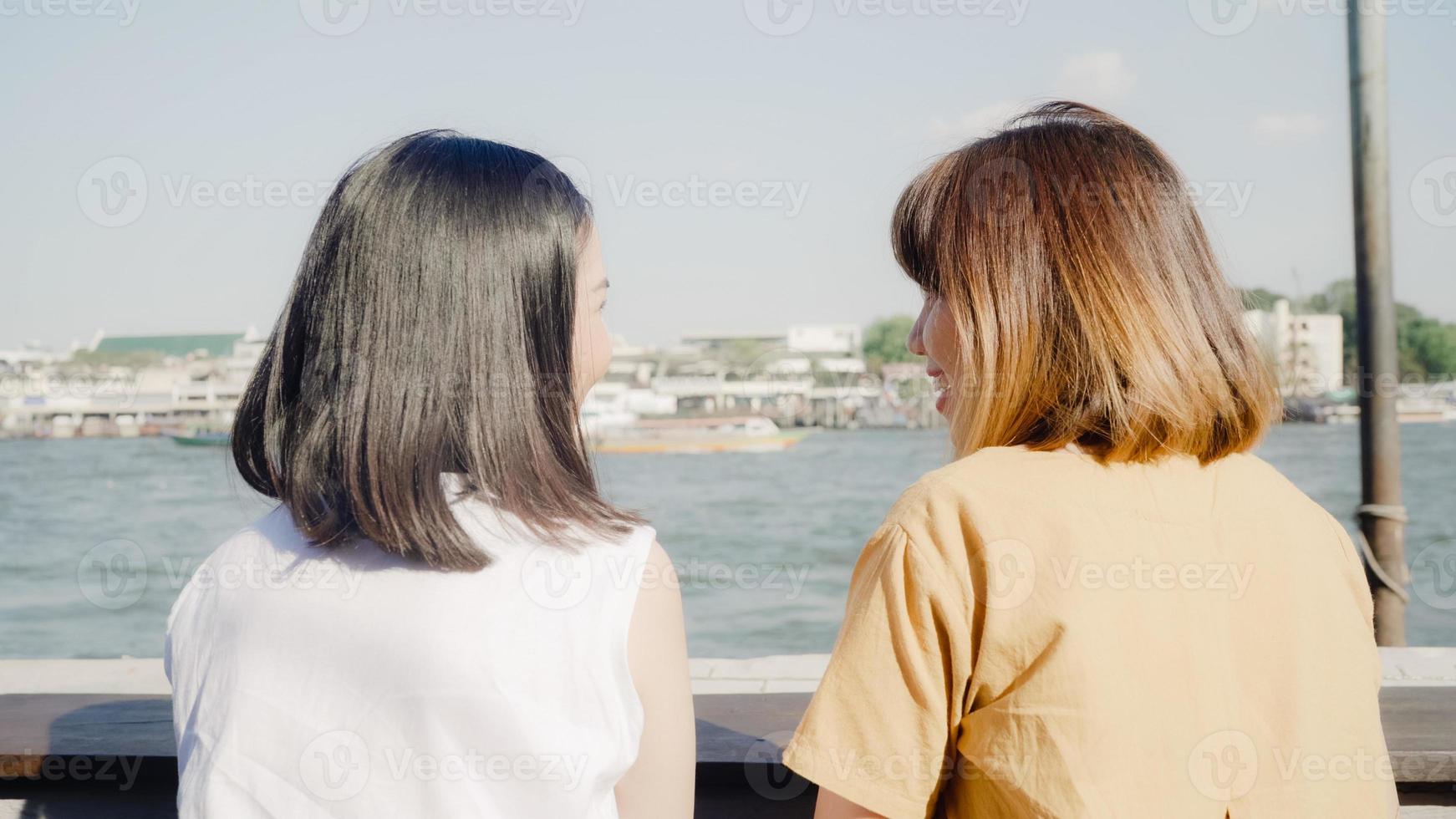 Young Asian women close friend tourist with casual enjoy talking gossip chat in front of port boat on the river feel happy joyful travel at cafe city town, Lifestyle tourist travel holiday concept. photo