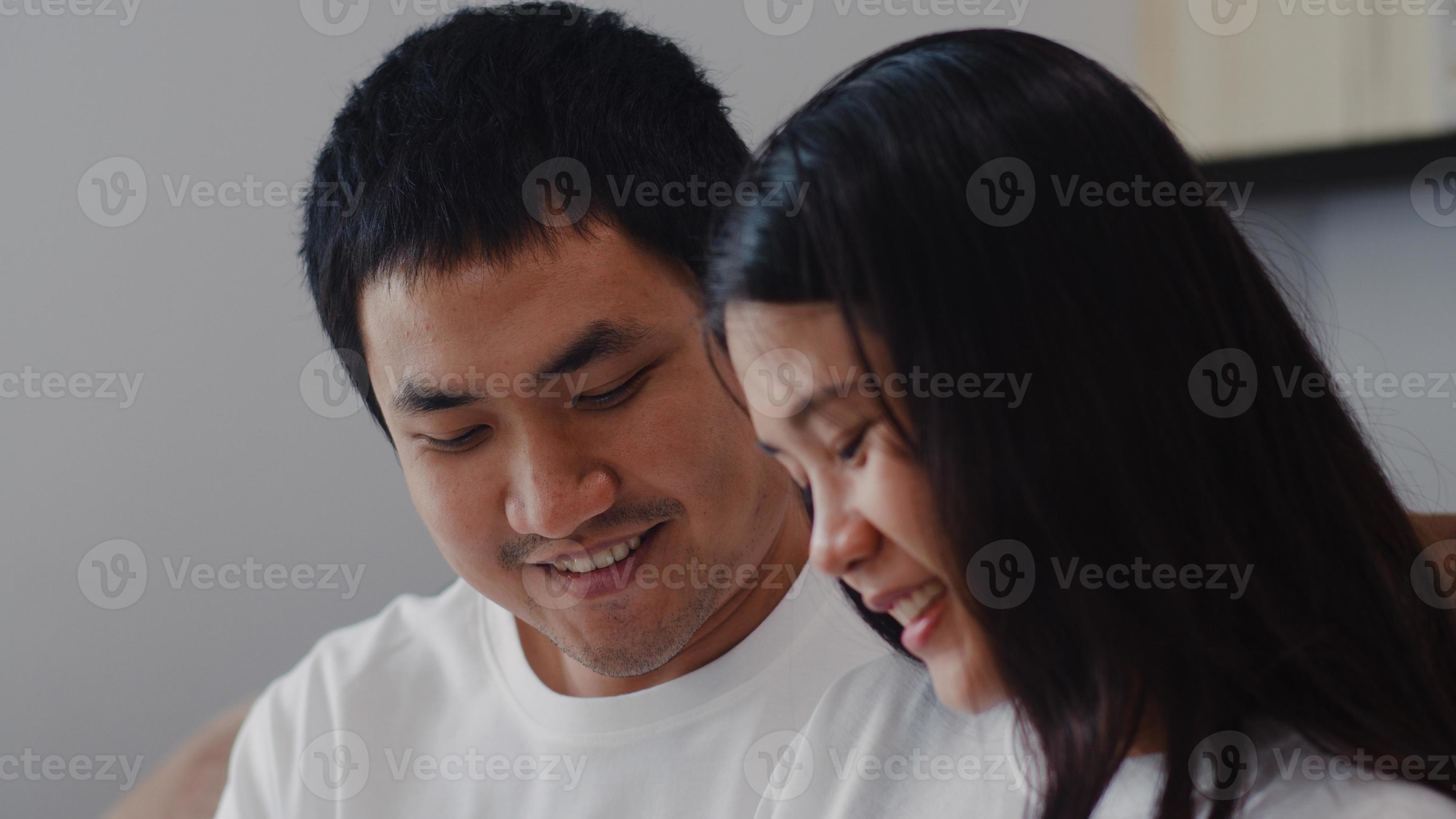 Young Asian Pregnant couple man touch his wife belly talking with his child pic