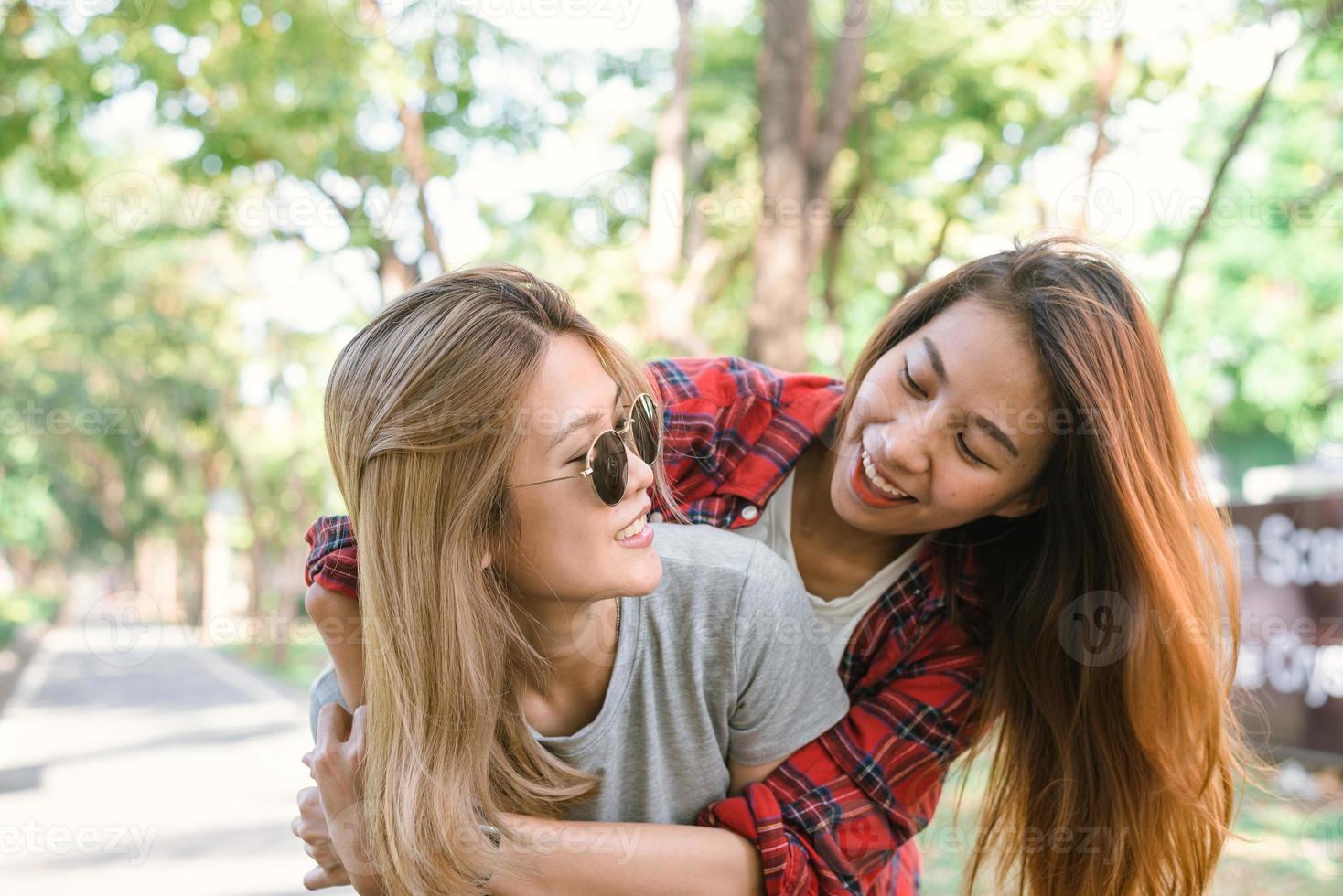 Happy young asian women couple playing to each other while they do city trip in warm sunlight morning weekend. City and nature lifestyle of Young women. Lifestyle in the city activity concept. photo