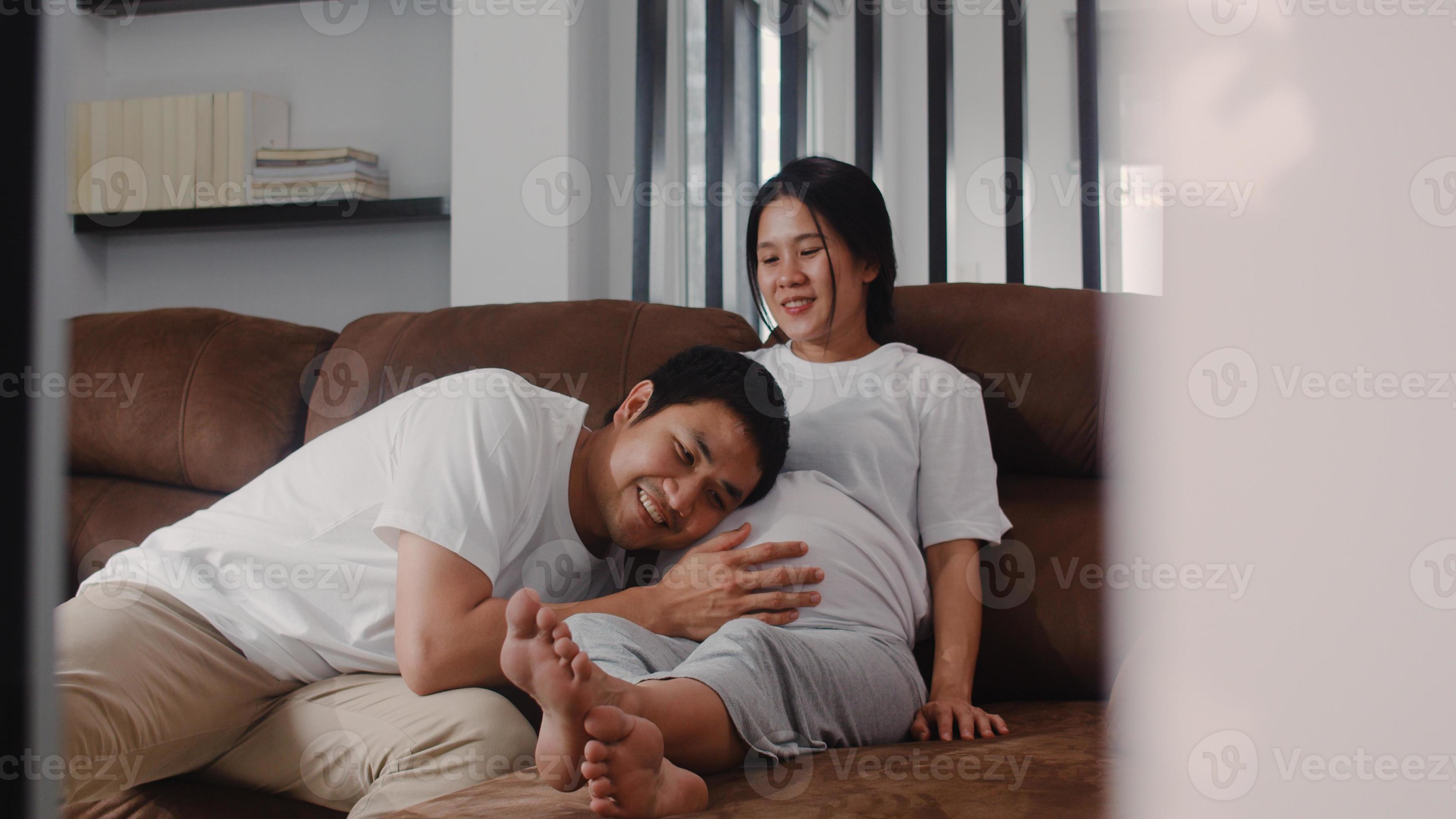 Young Asian Pregnant couple man kissing
