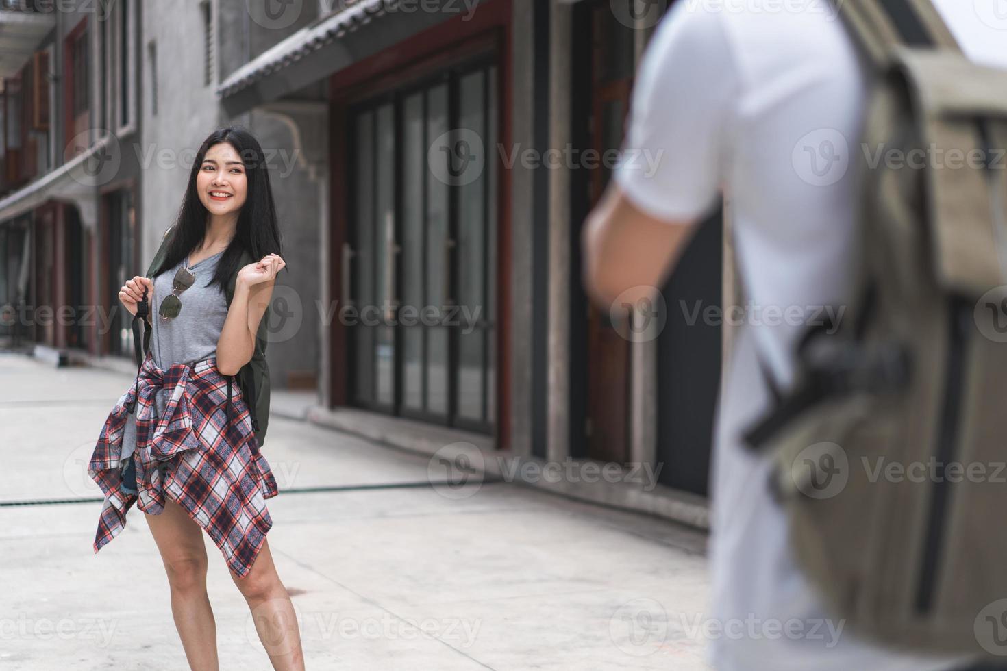 Traveler Asian couple travel in Beijing, China, sweet couple using camera taking photo each other near street while spending holiday trip. Lifestyle couple travel in city concept.