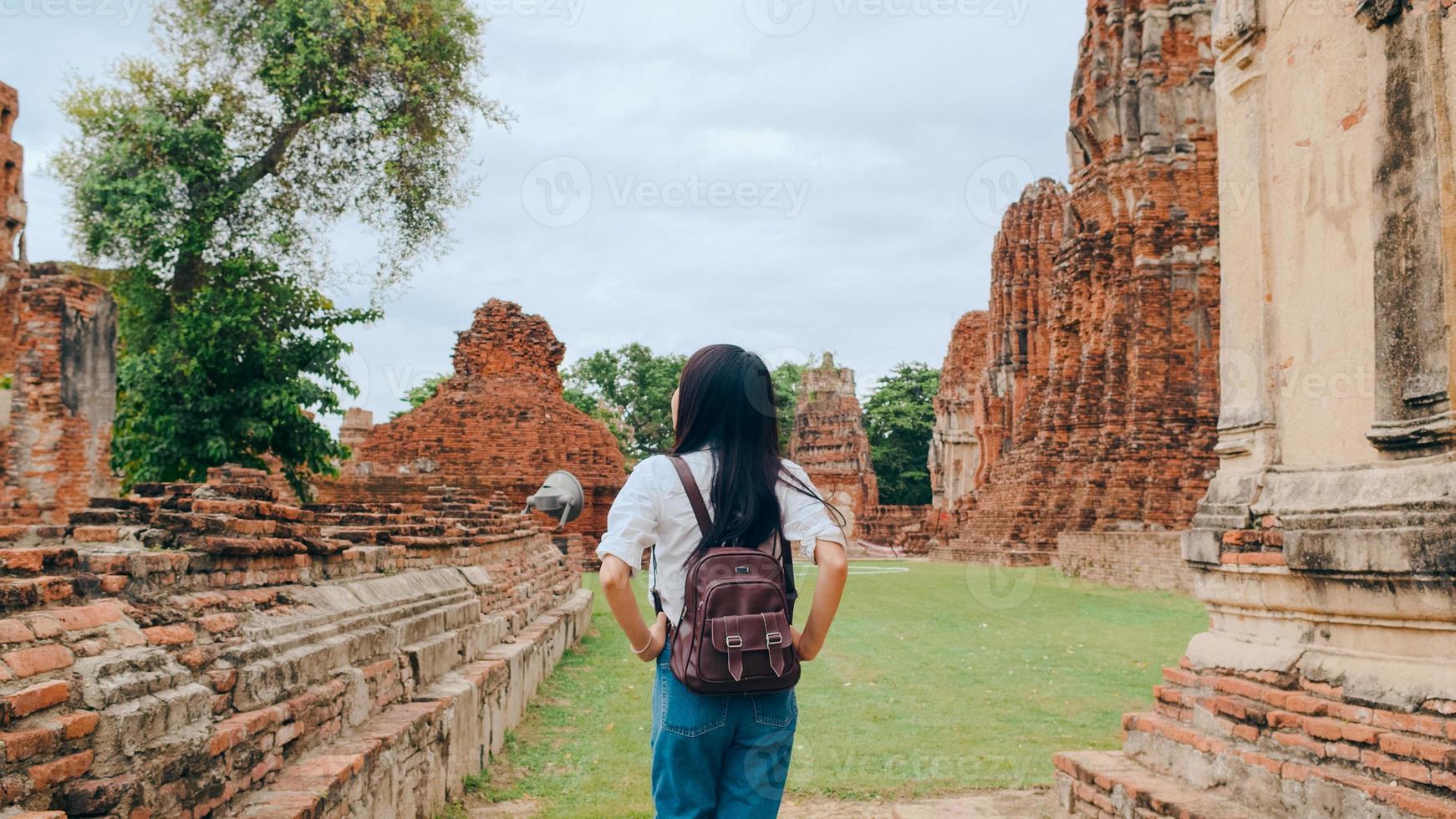 Traveler Asian woman spending holiday trip at Ayutthaya, Thailand, Japanese backpacker female enjoy her journey at amazing landmark in traditional city. Lifestyle women travel holidays concept. photo