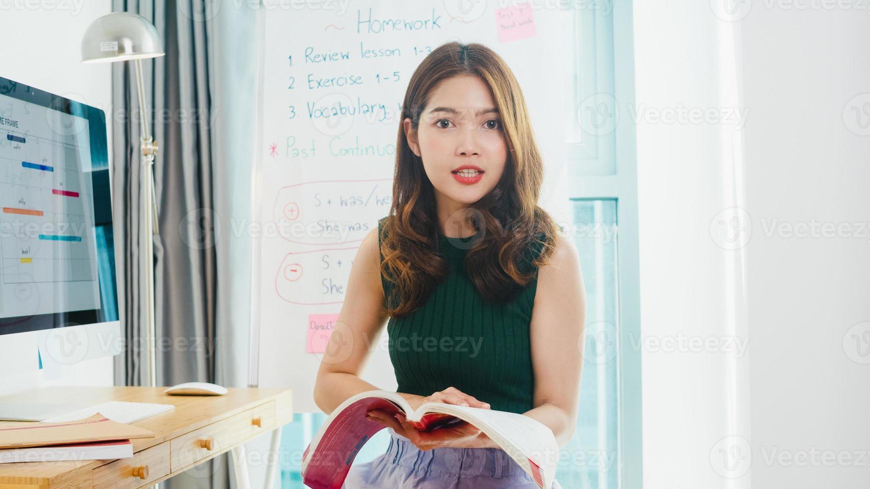 Asia young female english teacher video conference looking at camera talk by webcam learn teach in online chat at home. Remote education, Social distancing, quarantine for corona virus prevention. photo