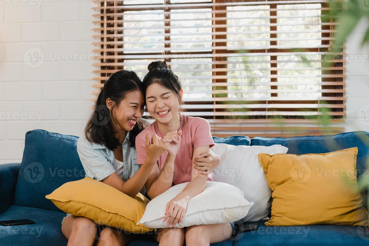 Young Lesbian lgbtq Asian women couple angry conflict together at home. Asia female sad flight annoyed on sofa in living room, teenager young girl upset, break up, unhappy concept. photo