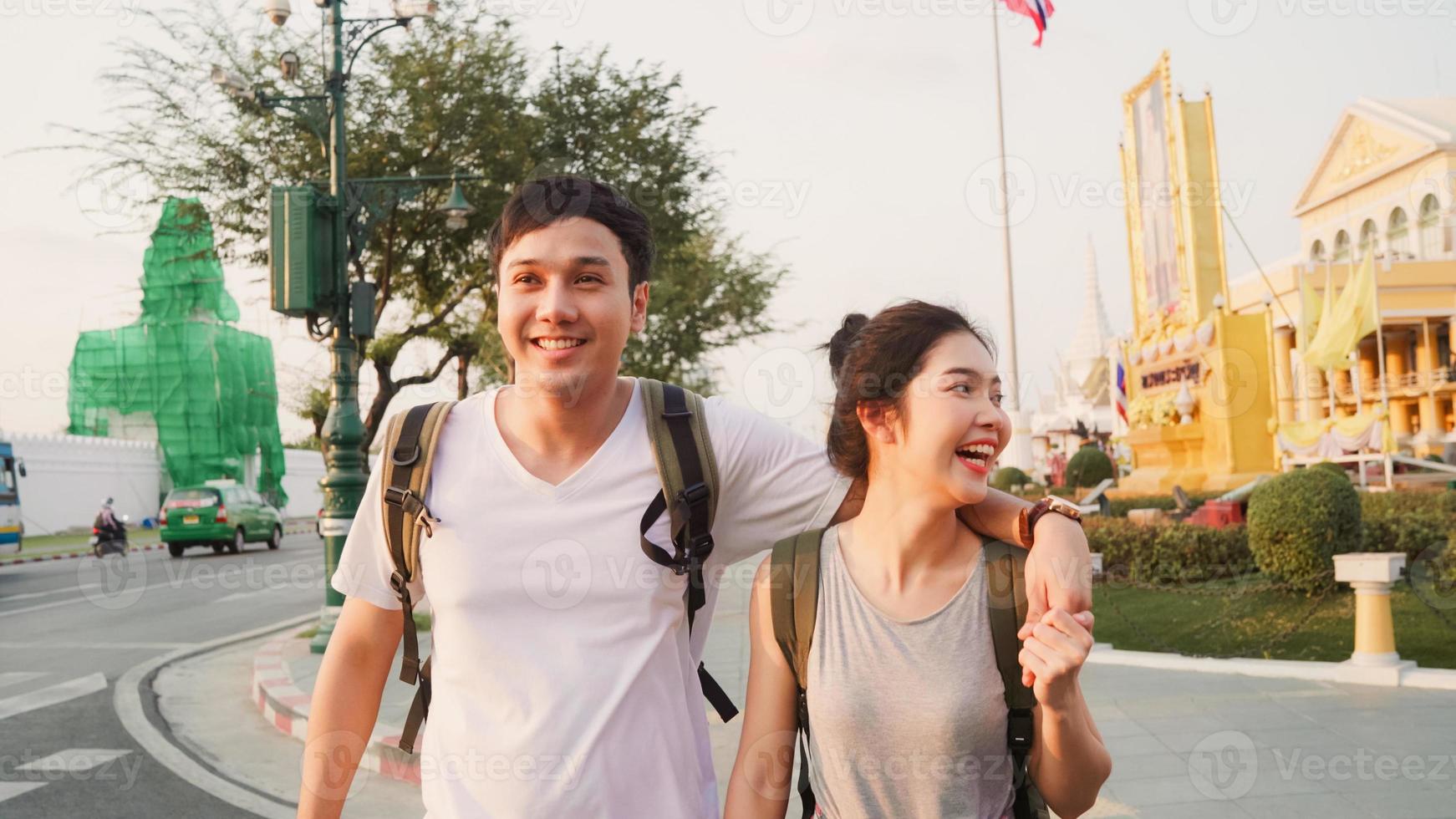 Traveler Asian couple traveling and walking in Bangkok, Thailand, sweet Asia couple feeling happy spending sweet time in holiday trip in sunset. Lifestyle couple travel in city concept. photo