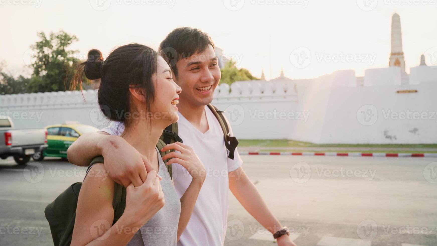 Traveler Asian couple traveling and walking in Bangkok, Thailand, sweet Asia couple feeling happy spending sweet time in holiday trip in sunset. Lifestyle couple travel in city concept. photo