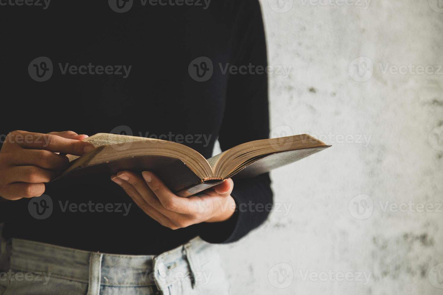 Women reading the old heavy book on white background. photo