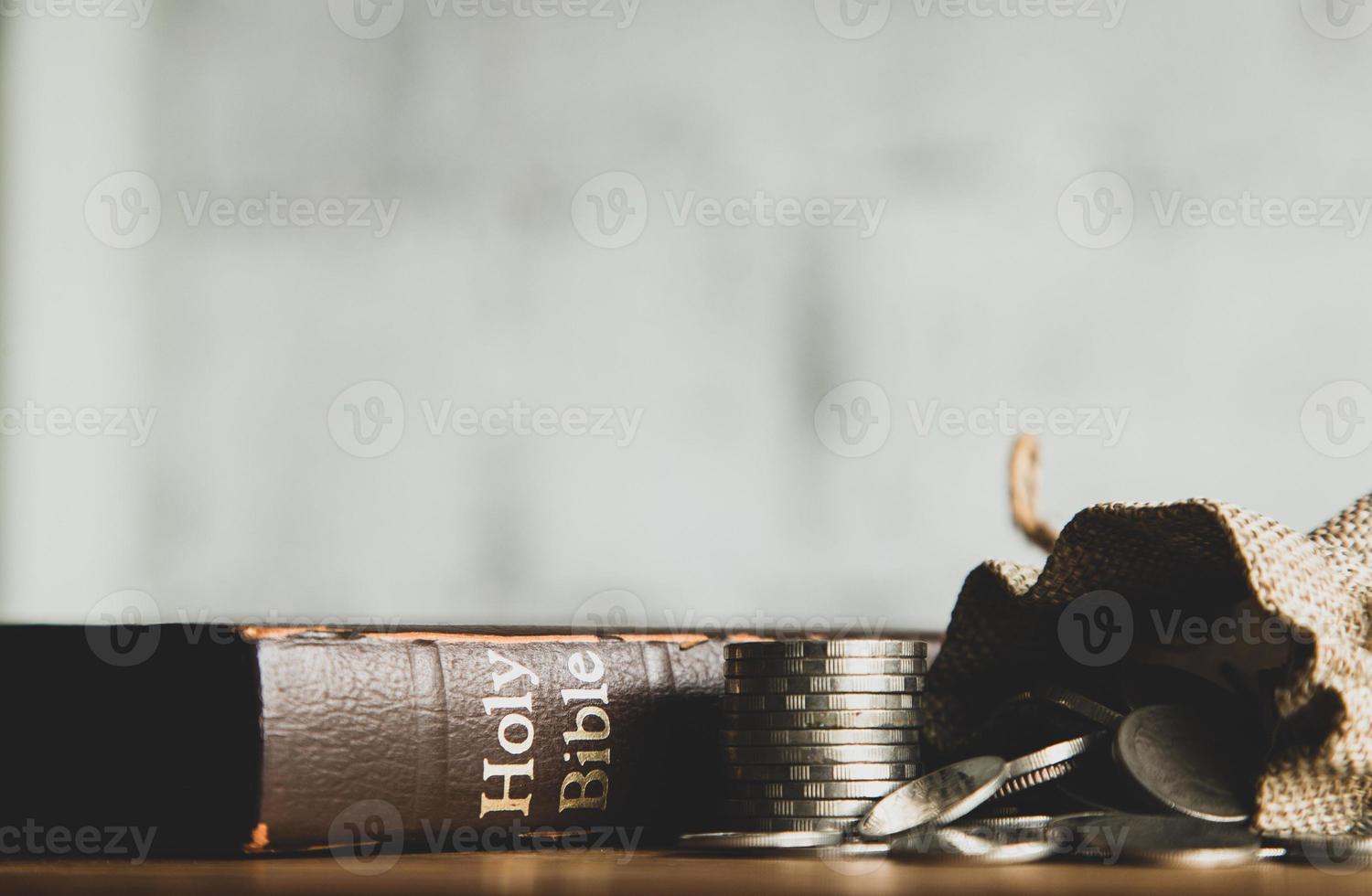 Holy bible with note book and pencil on wooden table, copy space photo