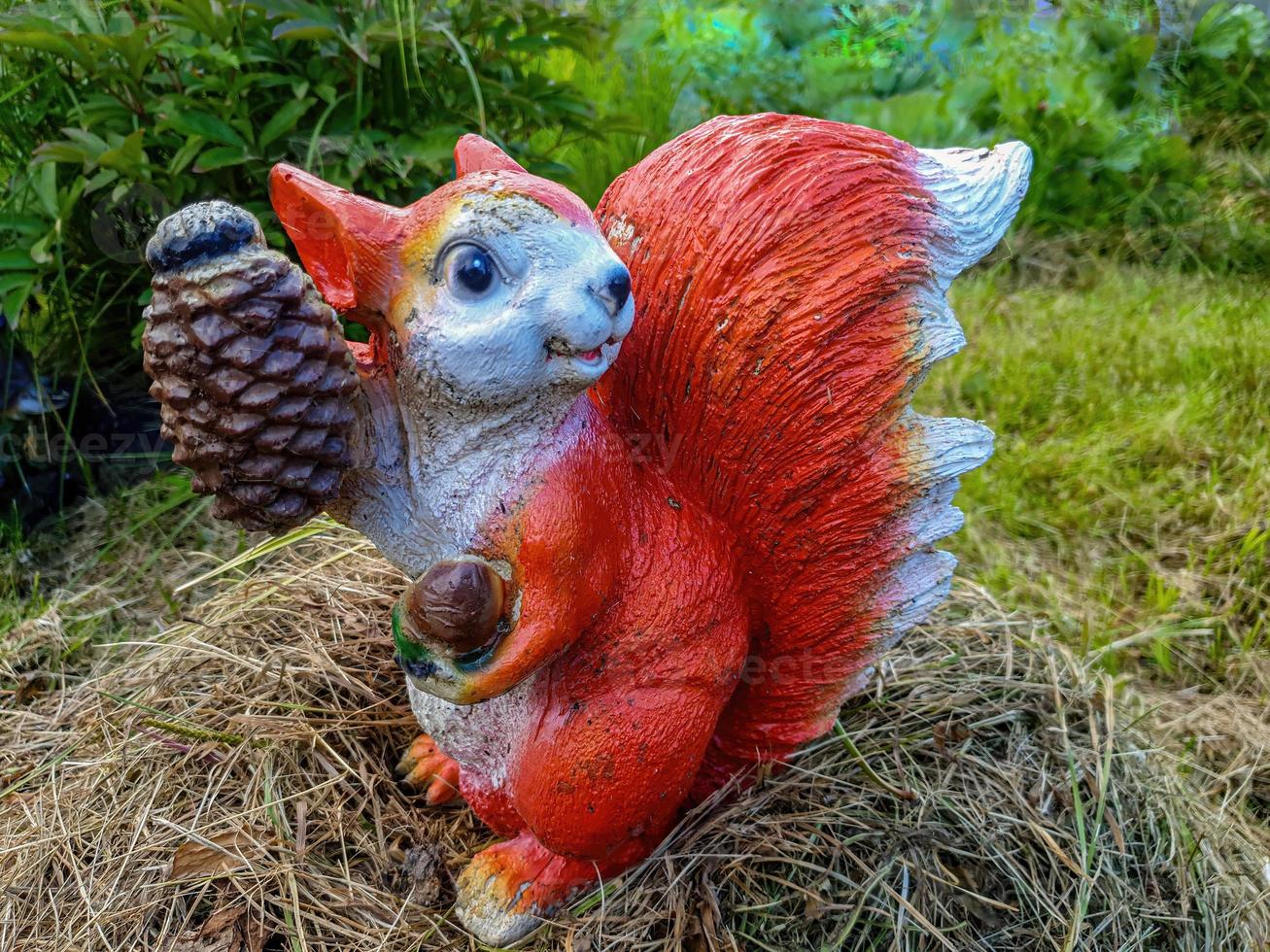 Decorative garden decoration in the form of a squirrel close-up. photo