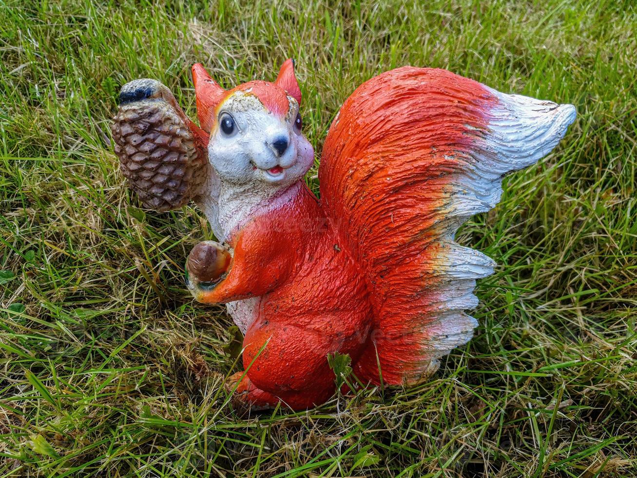 Decorative garden decoration in the form of a squirrel close-up. photo