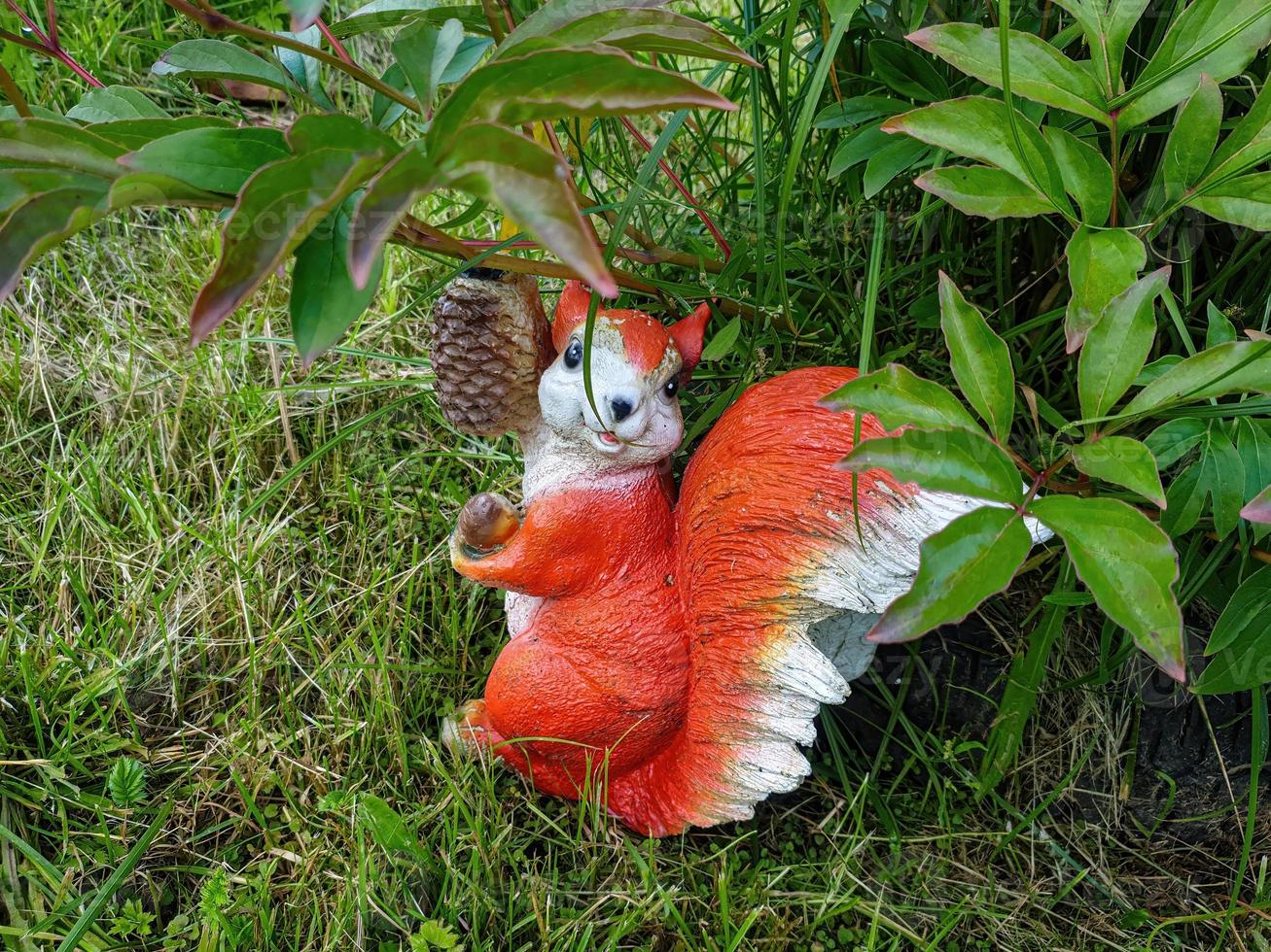Decorative garden decoration in the form of a squirrel. photo