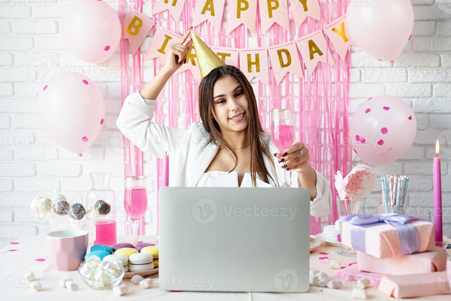 Beautiful woman celebrating birthday using video call chatting with friends photo