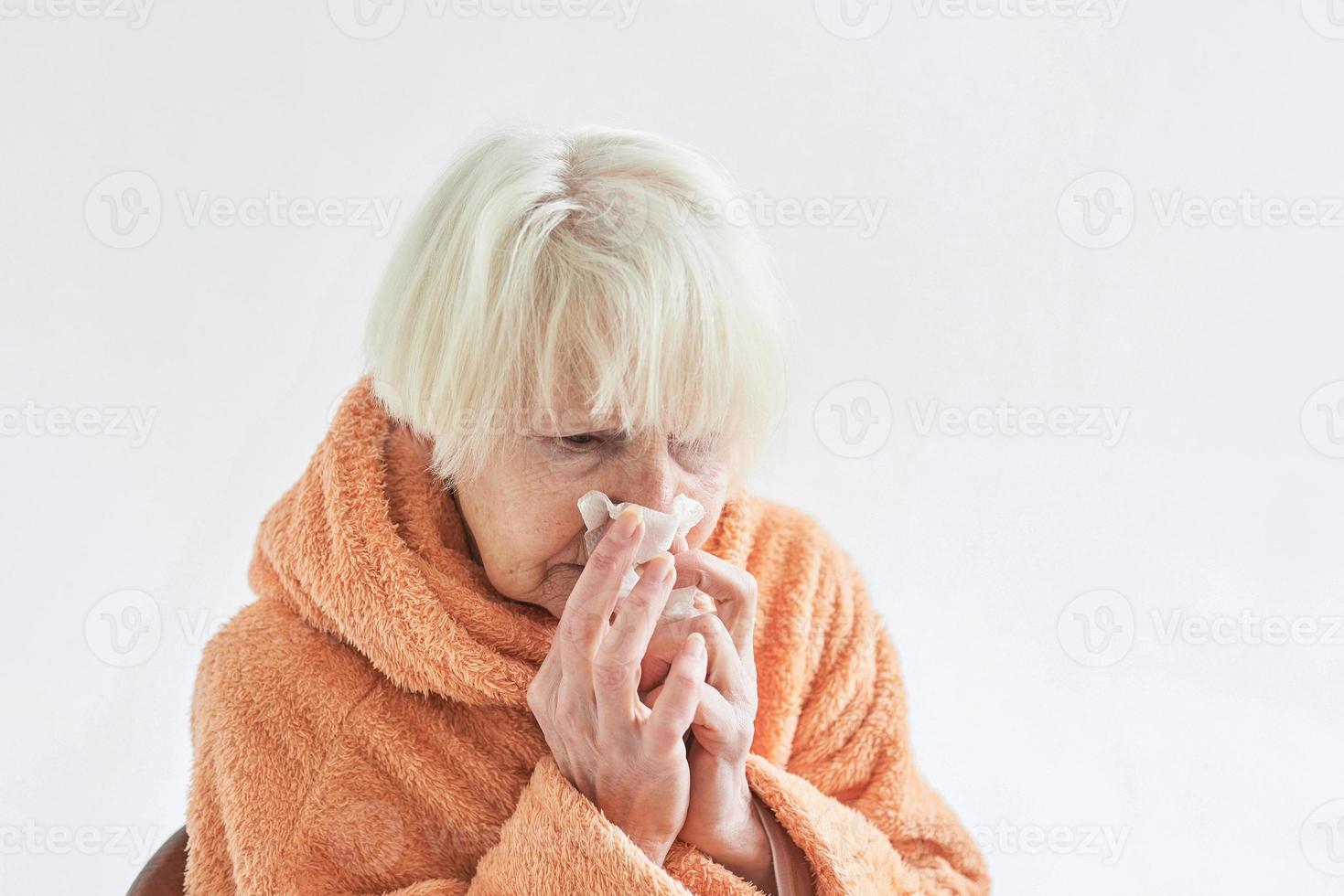 senior ill woman freezing cold at home. Health care, crisis, oldness concept photo