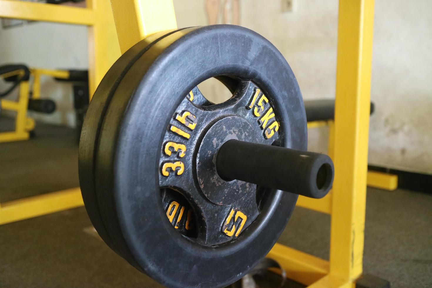 Editorial image of a 15 KG black barbell plate for exercising in the gym photo