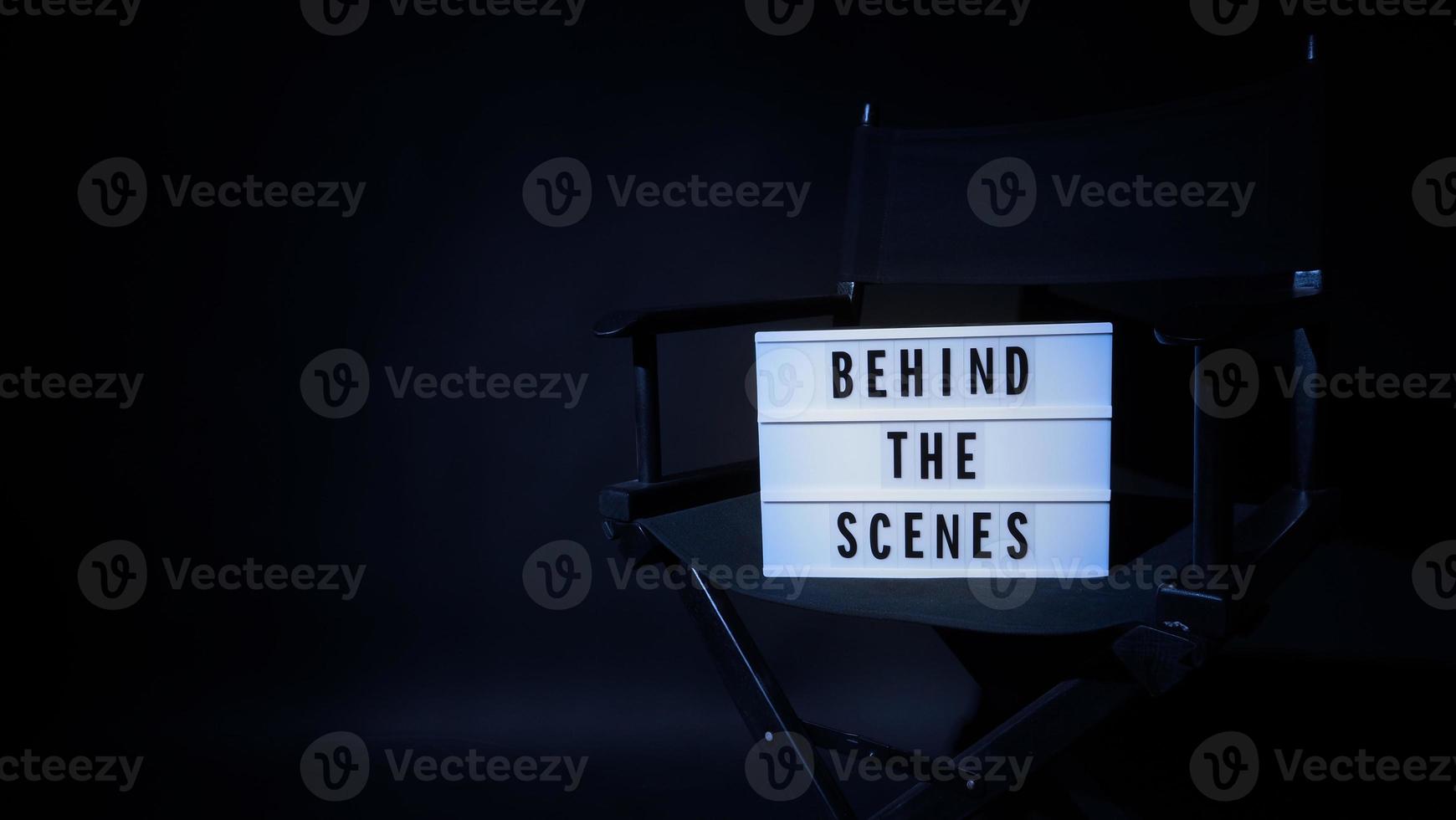Director chair with behind the scene banner light box. photo