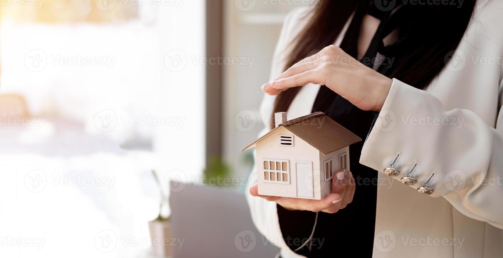 Close up of Real estate agent with house model for selling. Bank manager concept. photo