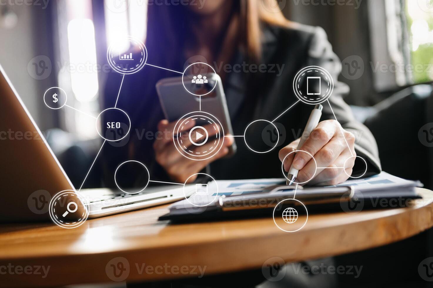 Businesswoman hand working digital marketing media in virtual screen with mobile phone and modern compute with VR icon diagram at office photo