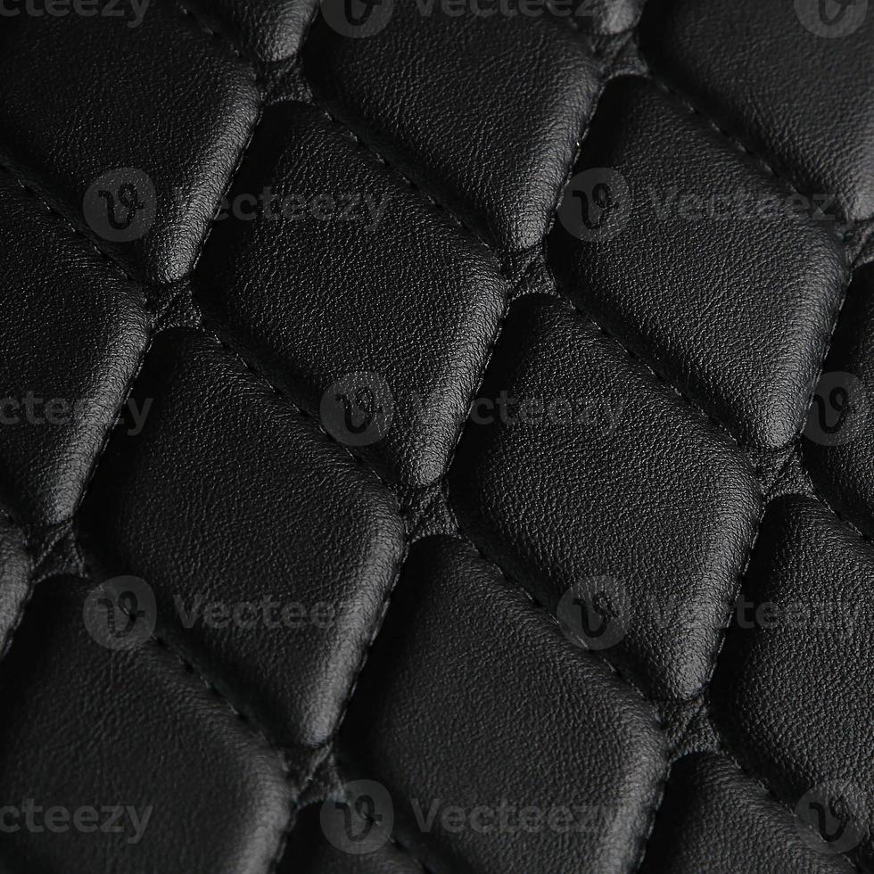Texture of black leather background with square pattern and stitch, macro photo