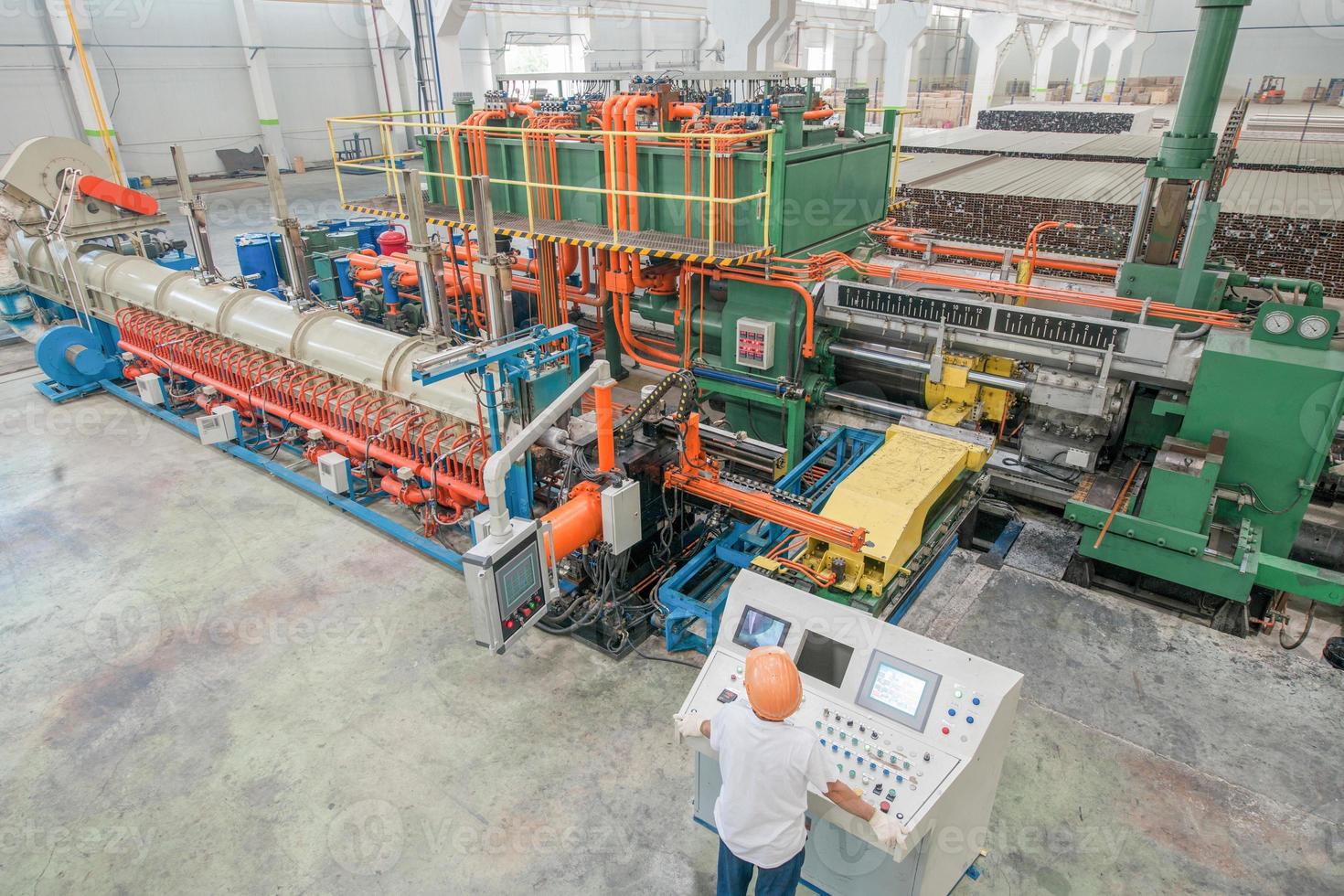 worker behind the dashboard in the workshop for the production of aluminum profiles. aluminum extrusion press photo