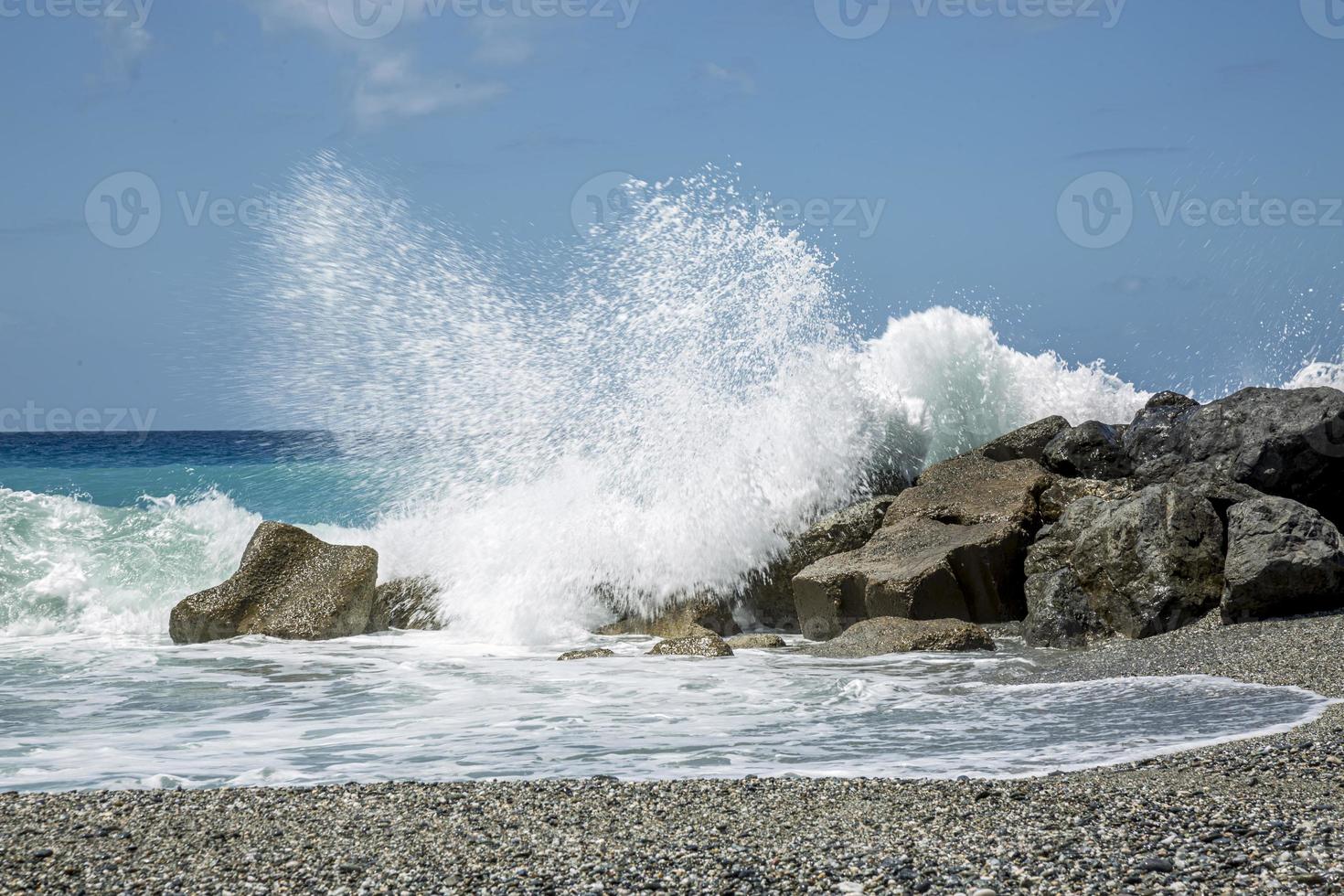 High wave breaking on the rocks of the coastline. photo