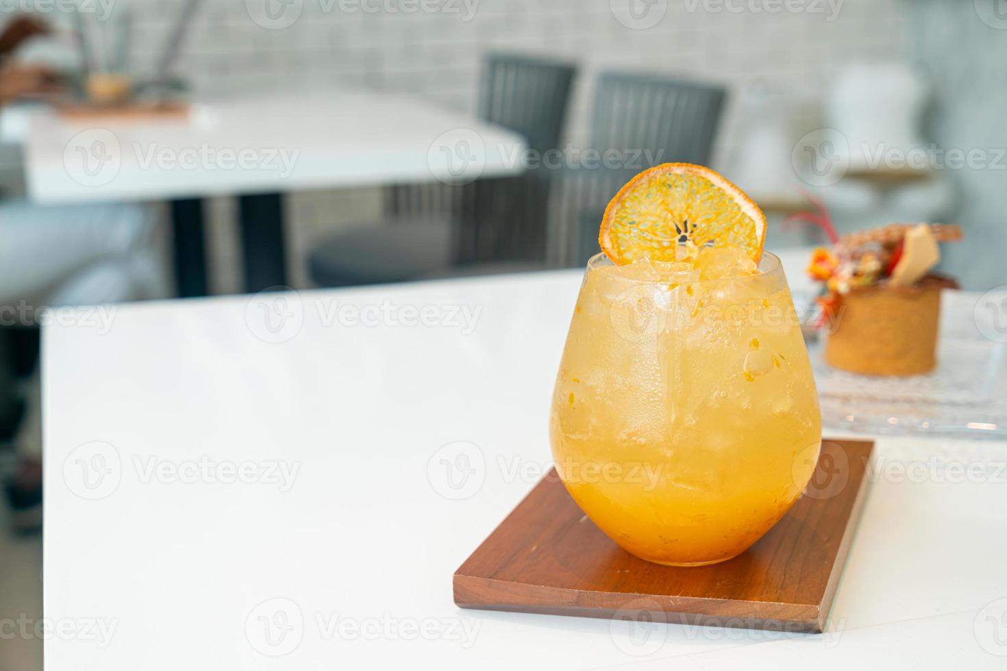 orange juice with soda on table photo
