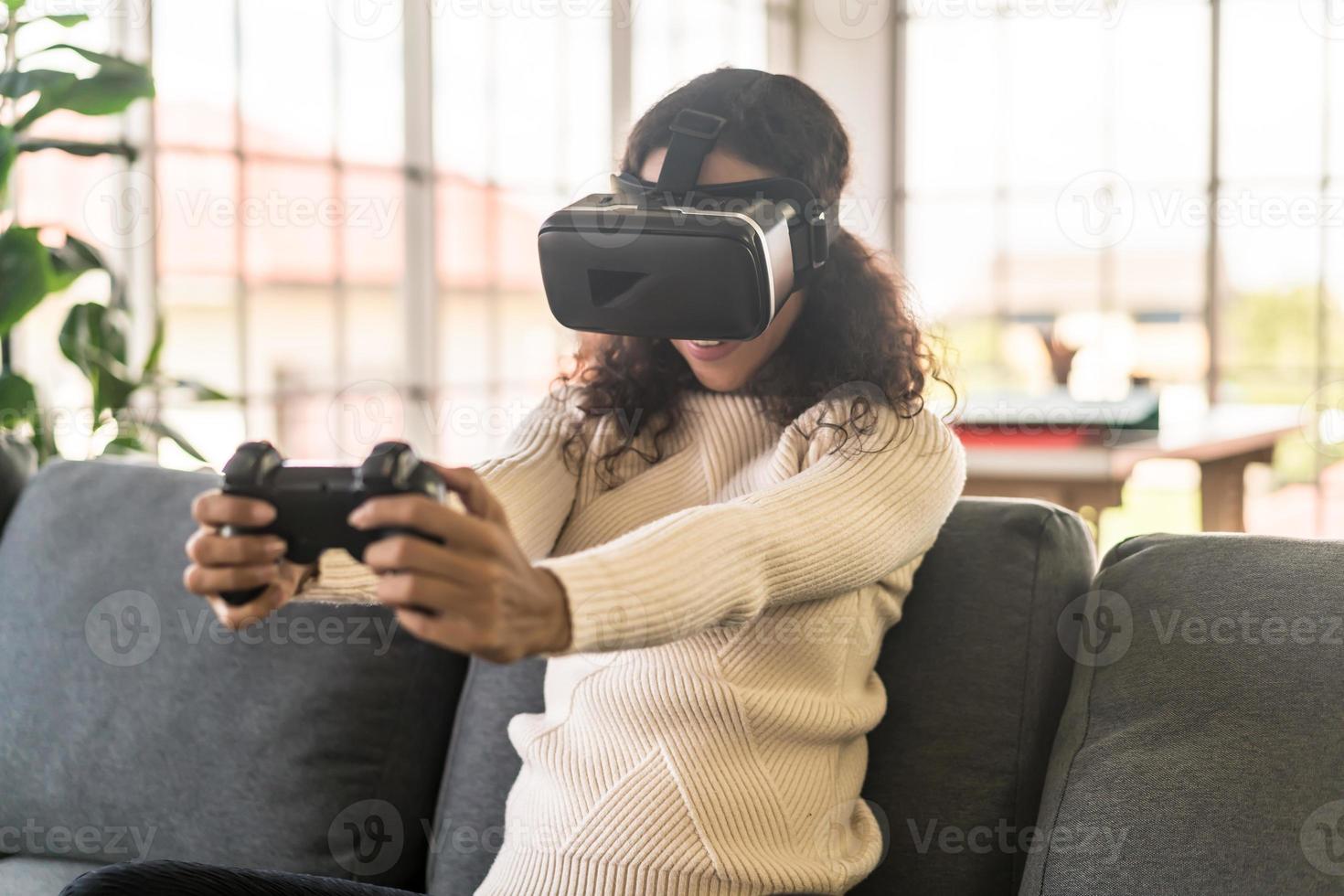 Latin woman using a virtual reality headset on sofa 5512622 Stock Photo