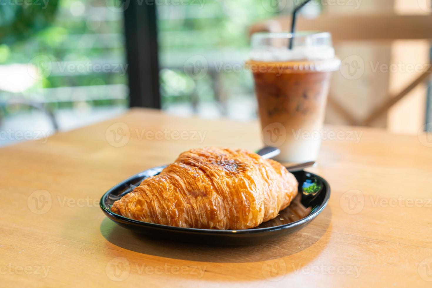 butter croissant on black plate photo