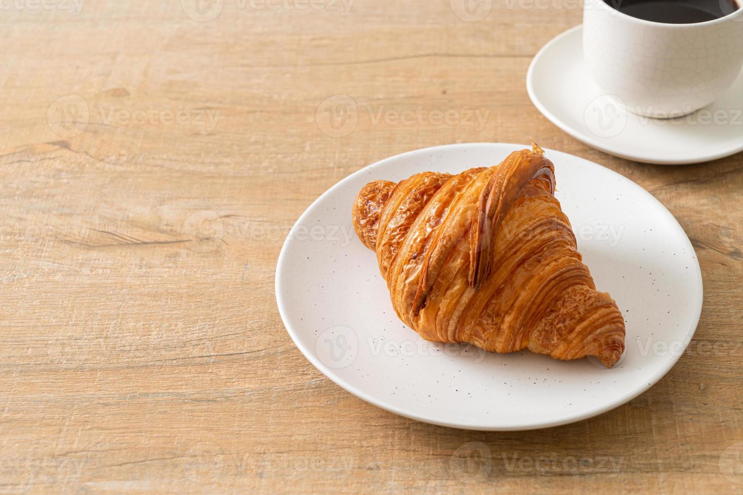 fresh croissant on white plate photo