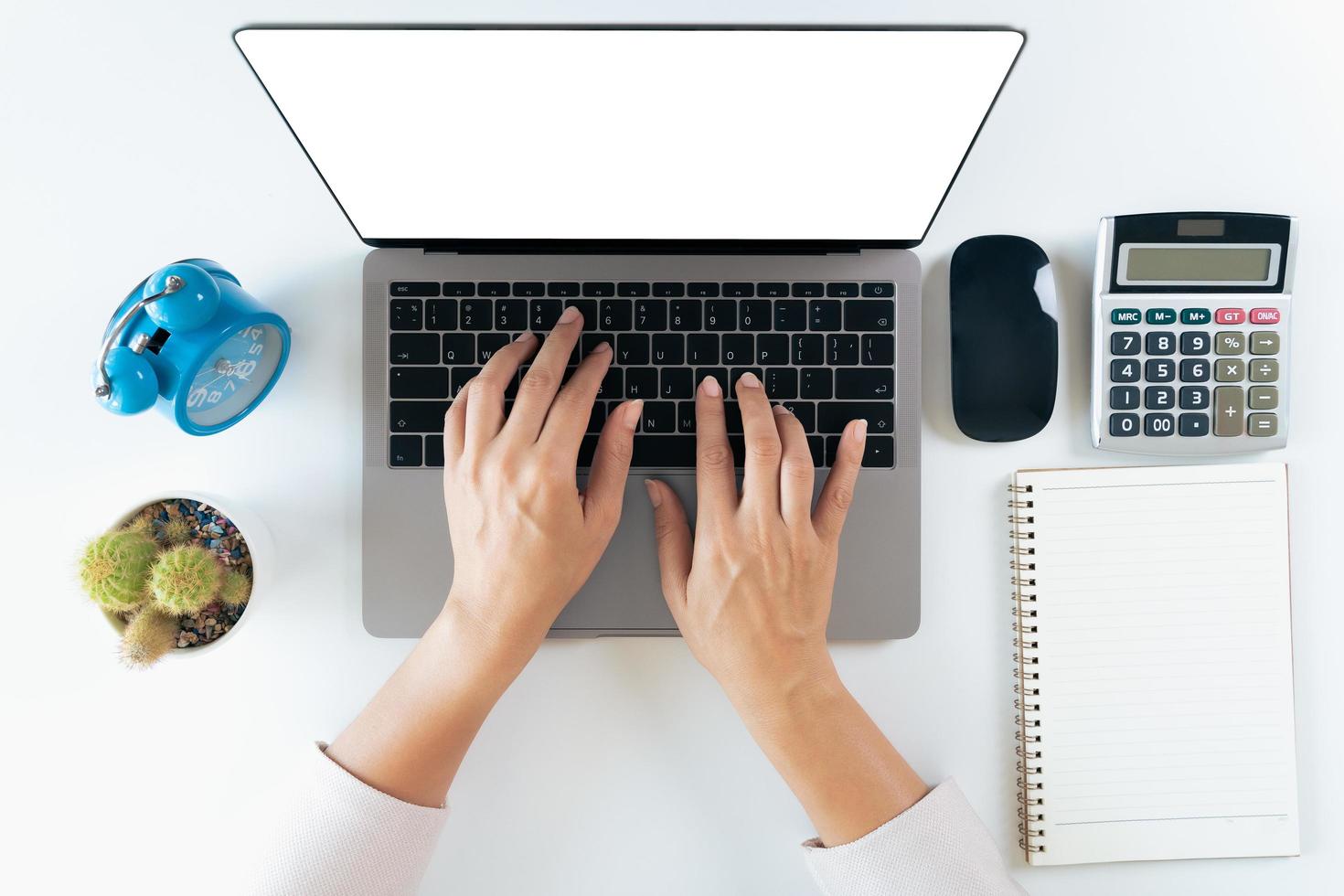 top view of woman hands typing on laptop keyboard on the table at home office or workplace. photo