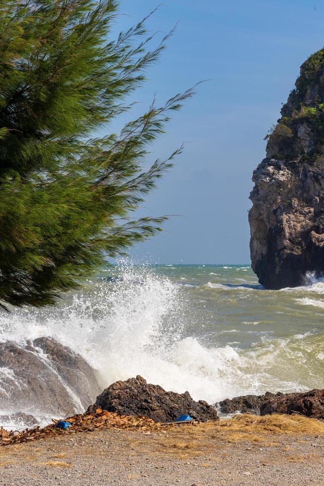 Waves and strong sea winds swept the rocks and shoals. Waves and sea breezes crash against rocks and shores. photo