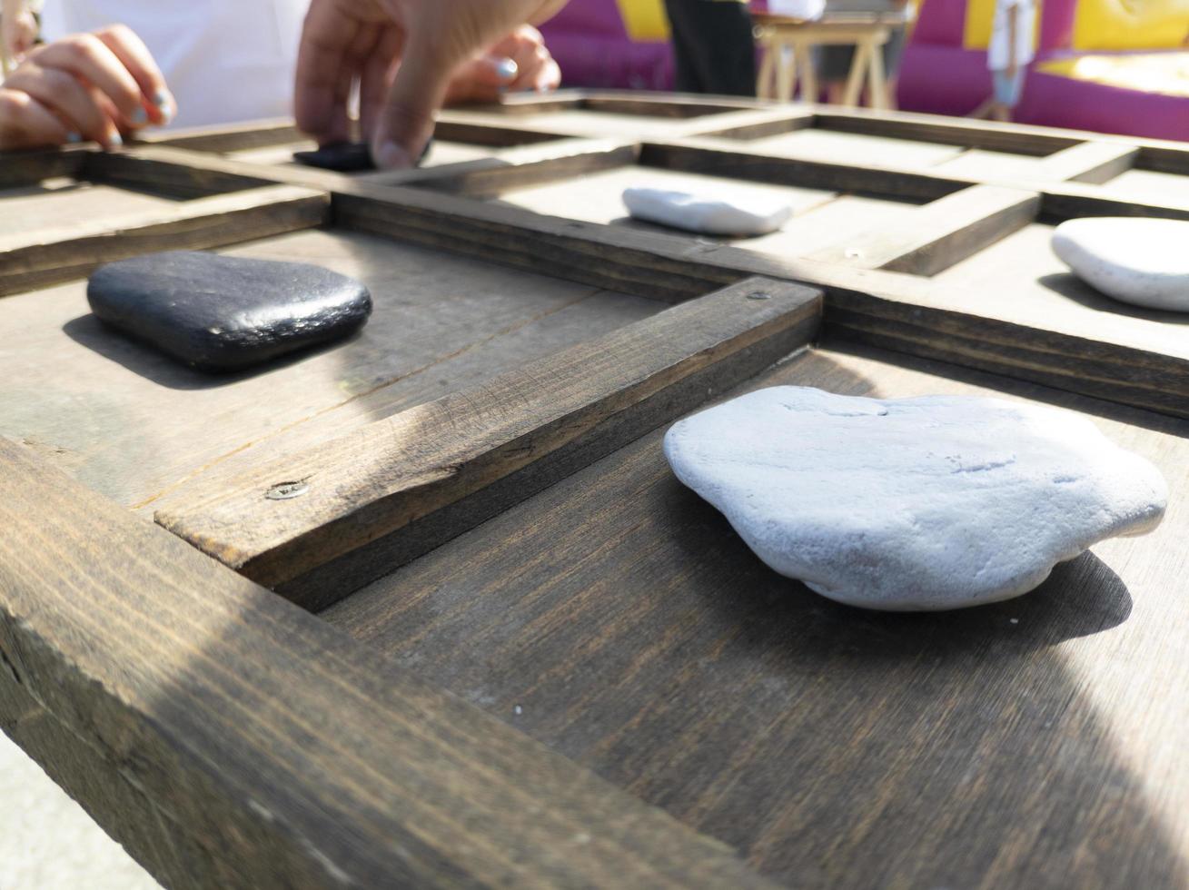 tic-tac-toe game made with wood and stones photo