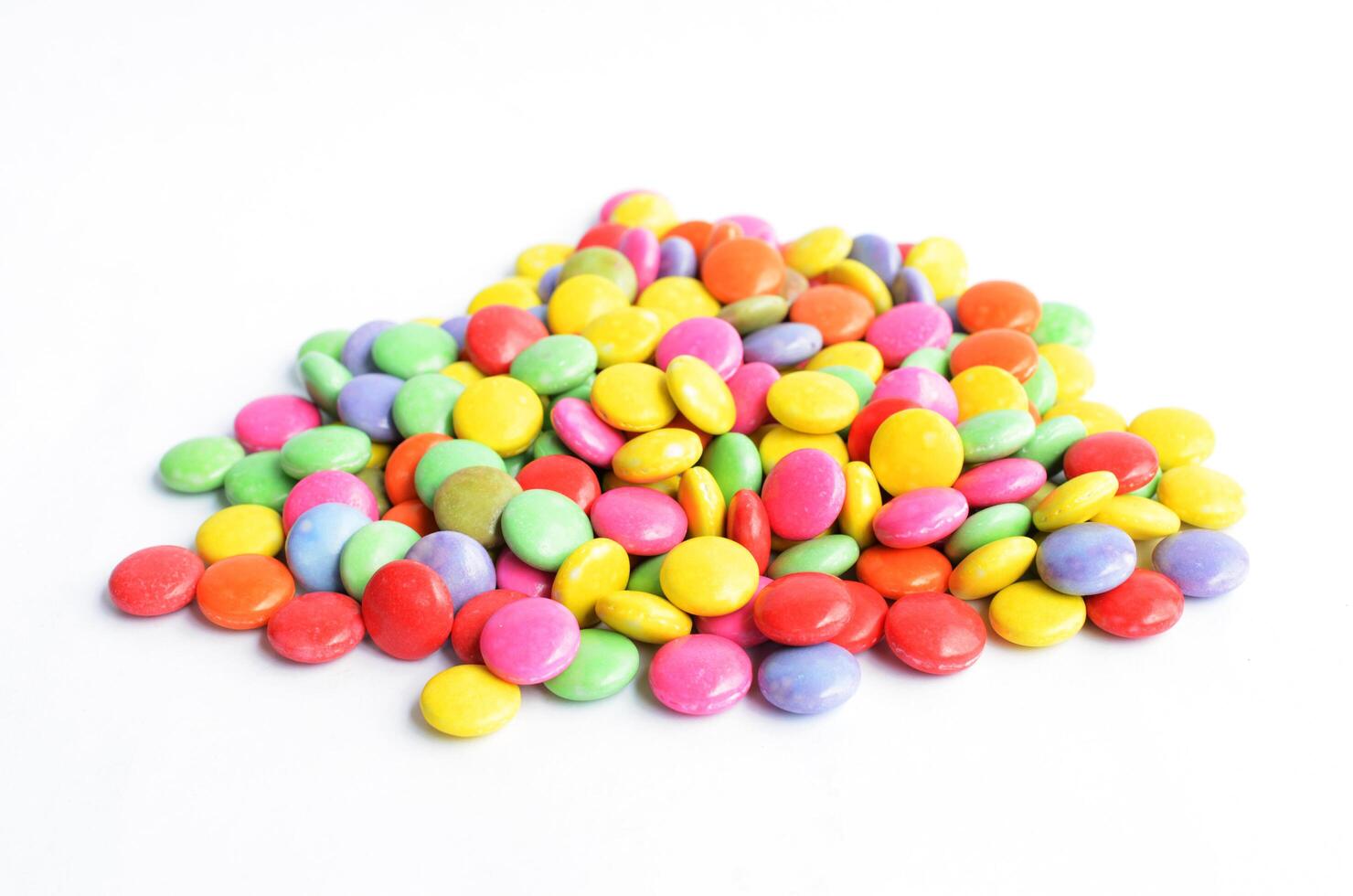 a pile of colorful chocolate coated candy Isolated on white backgrounds photo