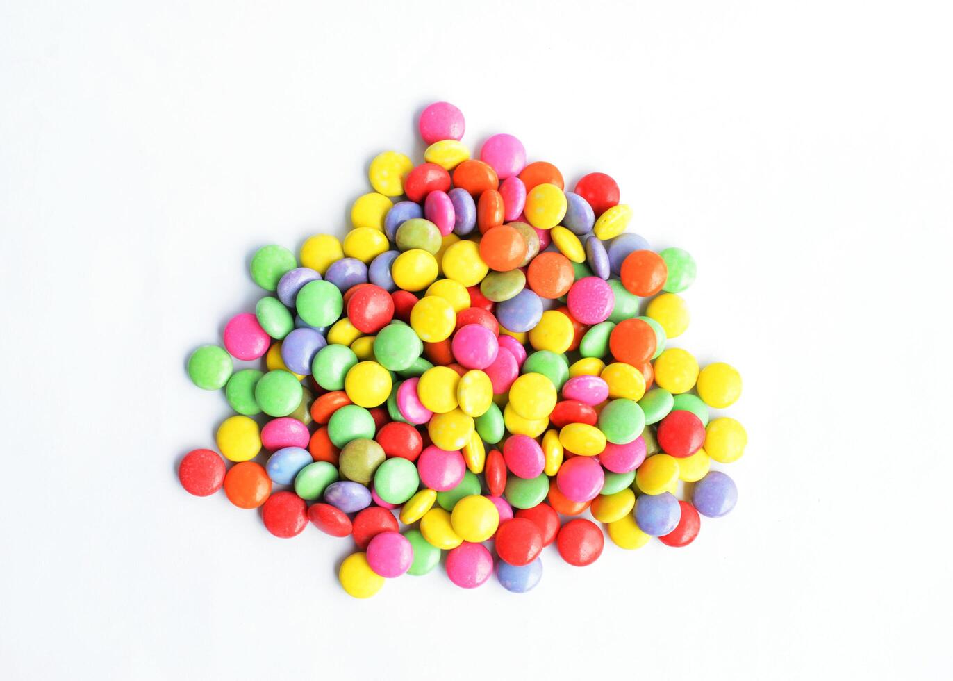 a pile of colorful chocolate coated candy Isolated on white backgrounds above photo