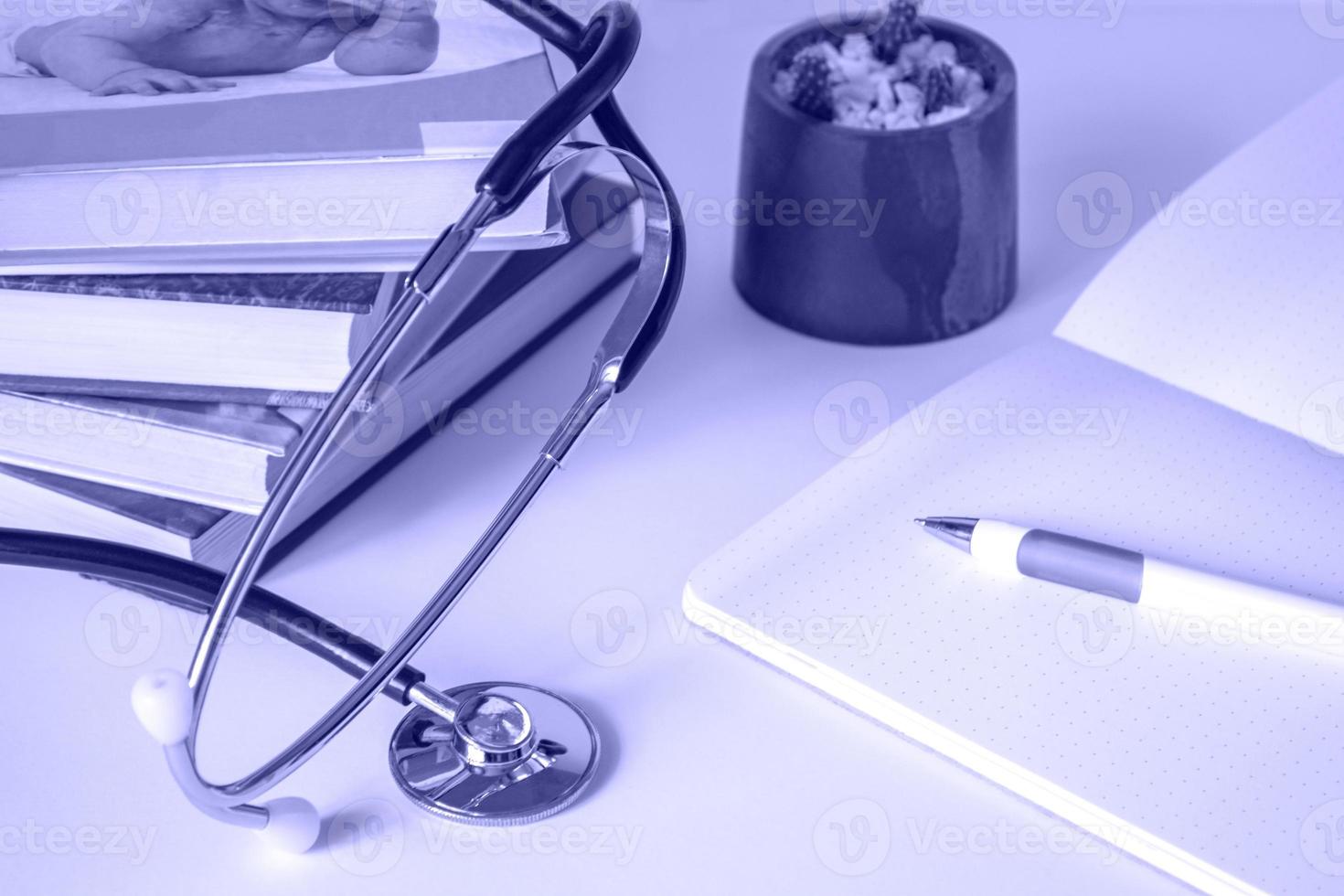 Doctor or student table with stethoscope, notepad, books. Medical education or advanced training concept. copy space photo