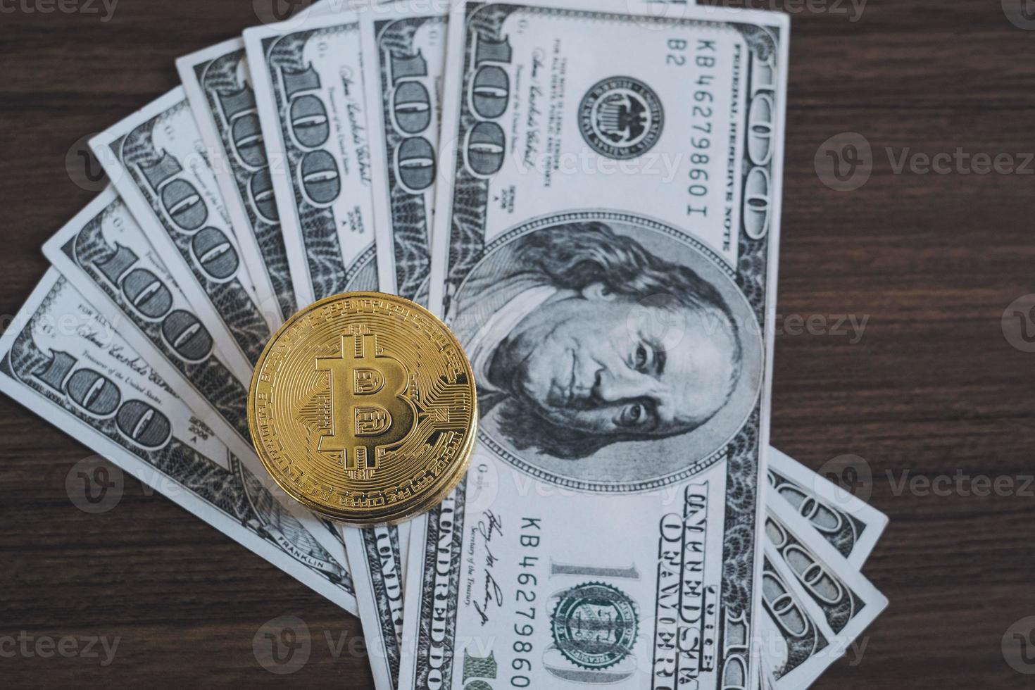 Golden bitcoin coin on us dollars close up. Bitcoin and cryptocurrency investing concept. photo