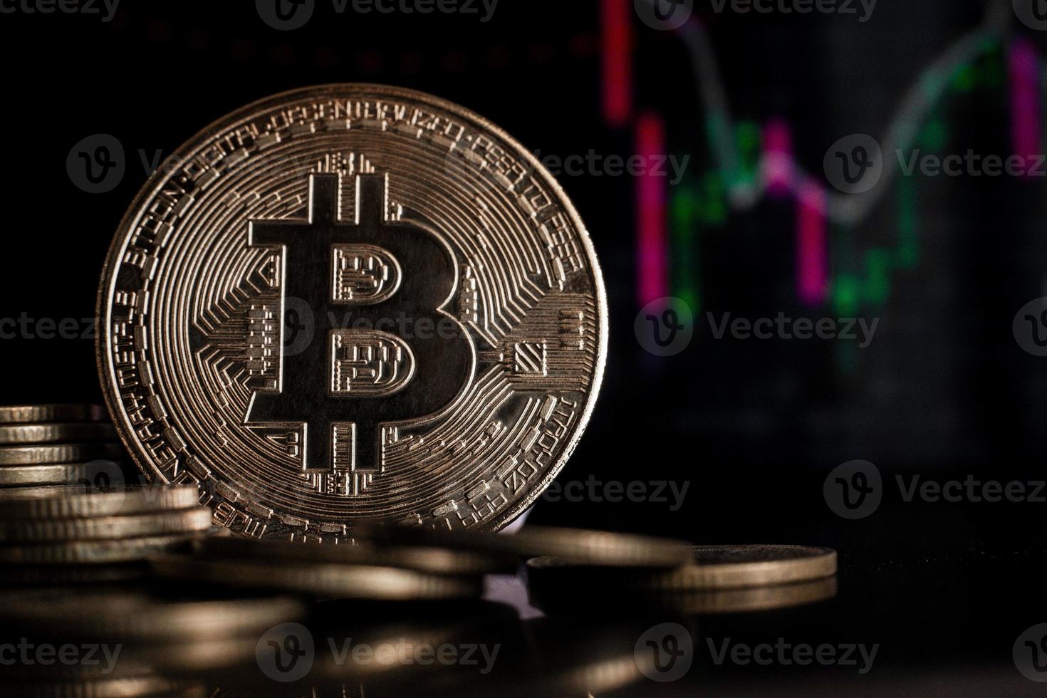 Bitcoin investments and taxes concept. Bitcoin gold coin and defocused chart background. Virtual cryptocurrency concept. photo